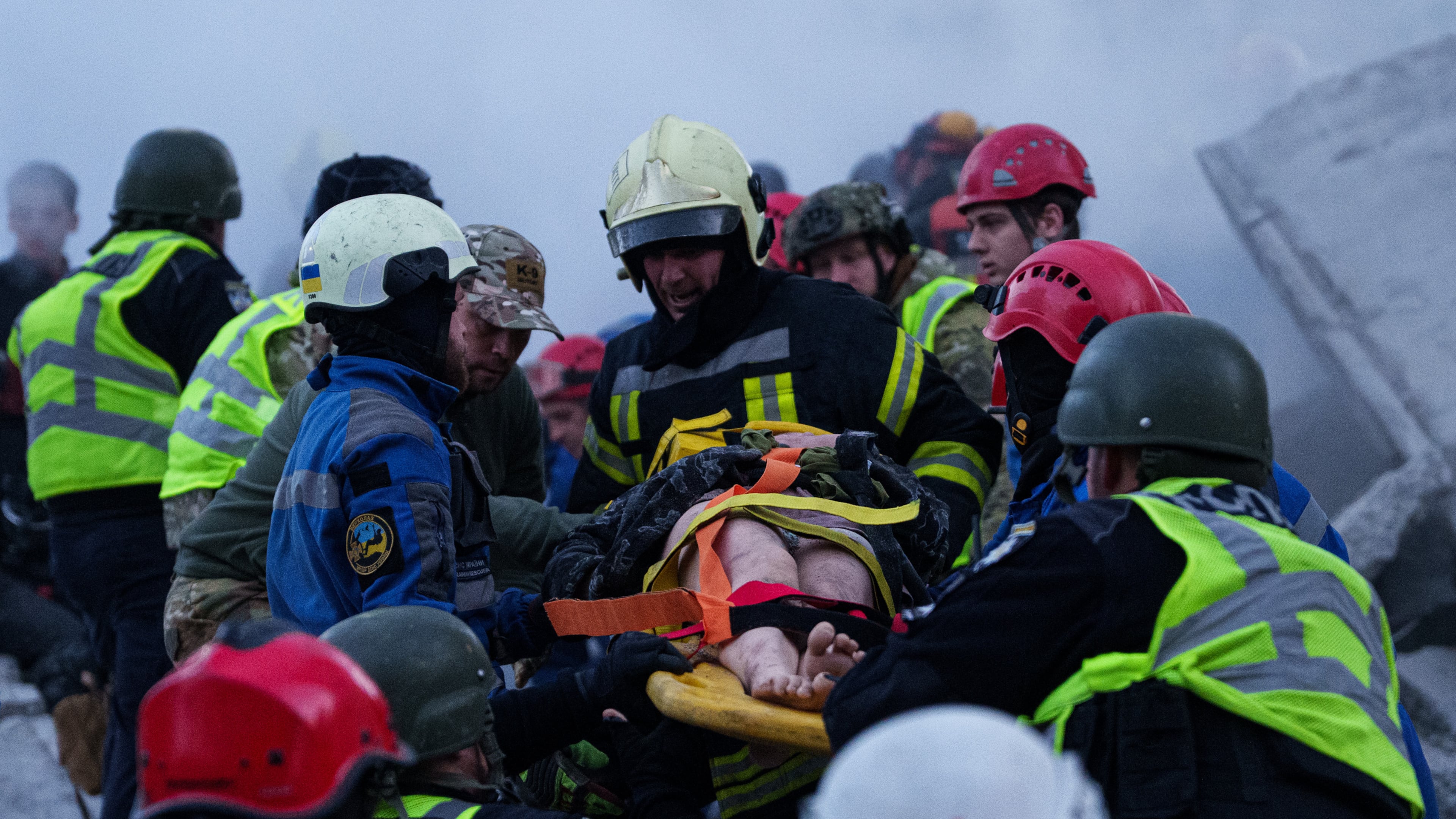 Rescue workers carry an injured woman on a stretcher from a house heavily damaged after a Russian strike on a residential neighborhood in Kyiv, Ukraine, on Thursday, May 14, 2026. (AP Photo/Evgeniy Maloletka)