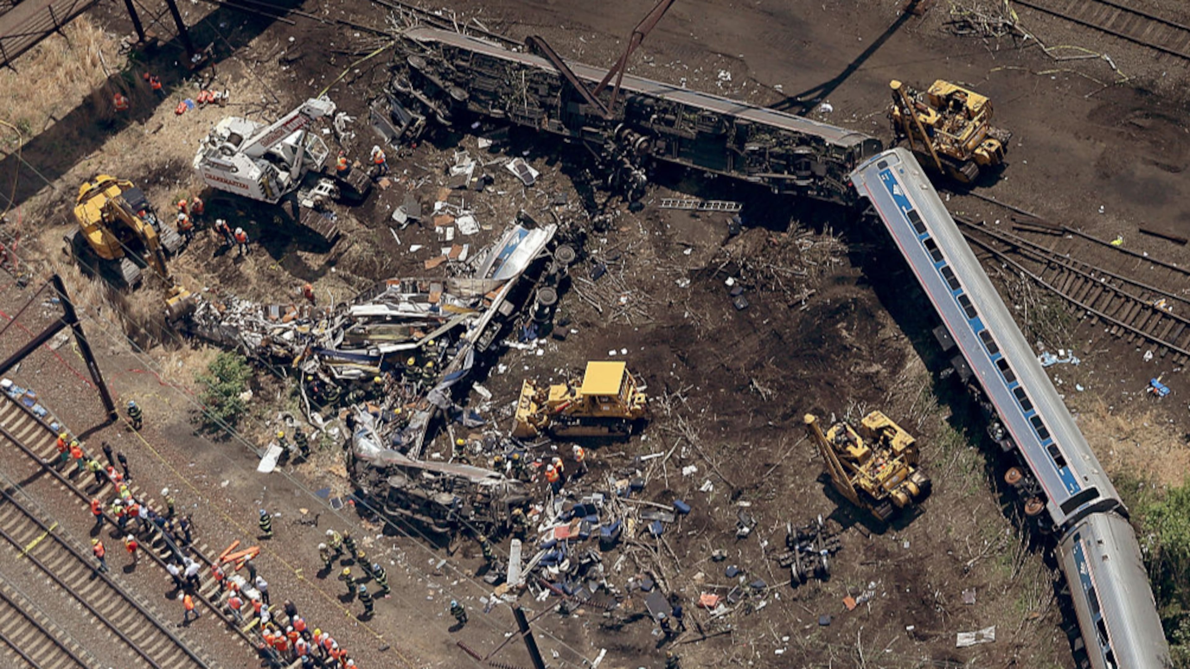 PHILADELPHIA, PA - MAY 13: Investigators and first responders work near the wreckage of Amtrak Northeast Regional Train 188, from Washington to New York, that derailed May 13, 2015 in north Philadelphia, Pennsylvania. At least six people were killed and more than 200 others were injured in the crash. (Photo by Win McNamee/Getty Images)