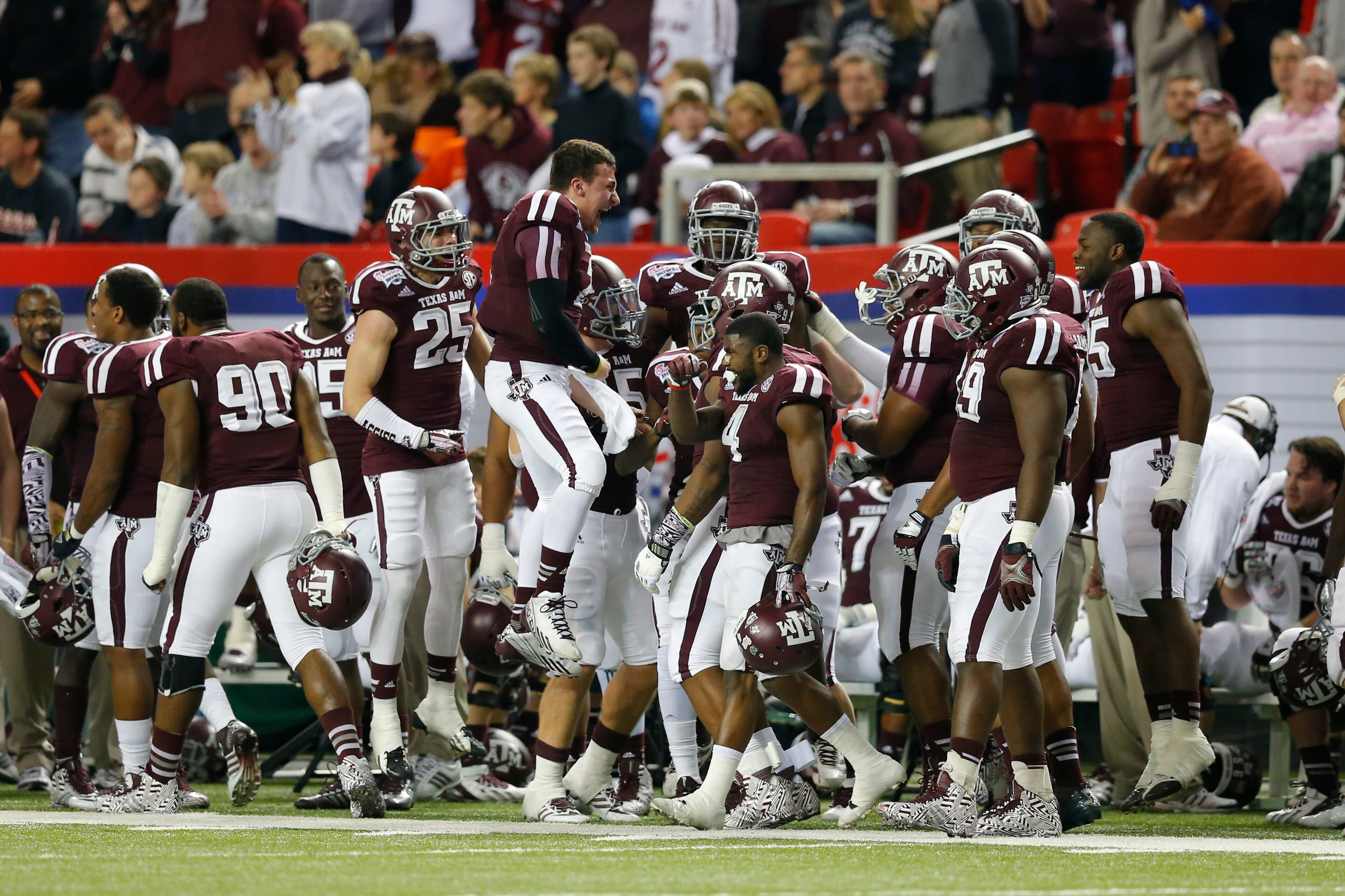 Texas A&M Aggies quarterback Johnny Manziel (2) celebrates with his teammates after a touchdown against the Duke Blue Devils during the 2013 Chick-fil-A Bowl at the Georgia Dome.