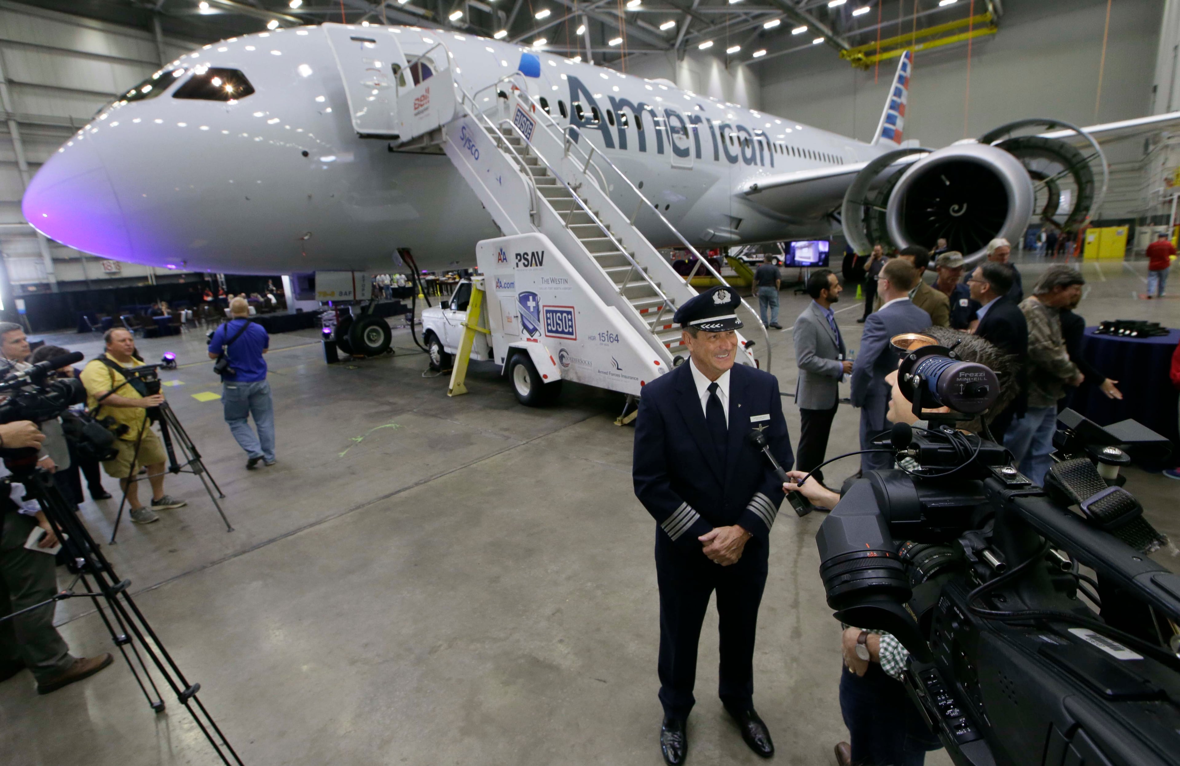 Captain Mike Riley gives an interview outside American Airlines first Boeing 787 Dreamliner at the airlines' maintenance hangar at Dallas-Fort Worth International Airport, Wednesday, April 29, 2015, in Grapevine, Texas. (AP Photo/LM Otero)