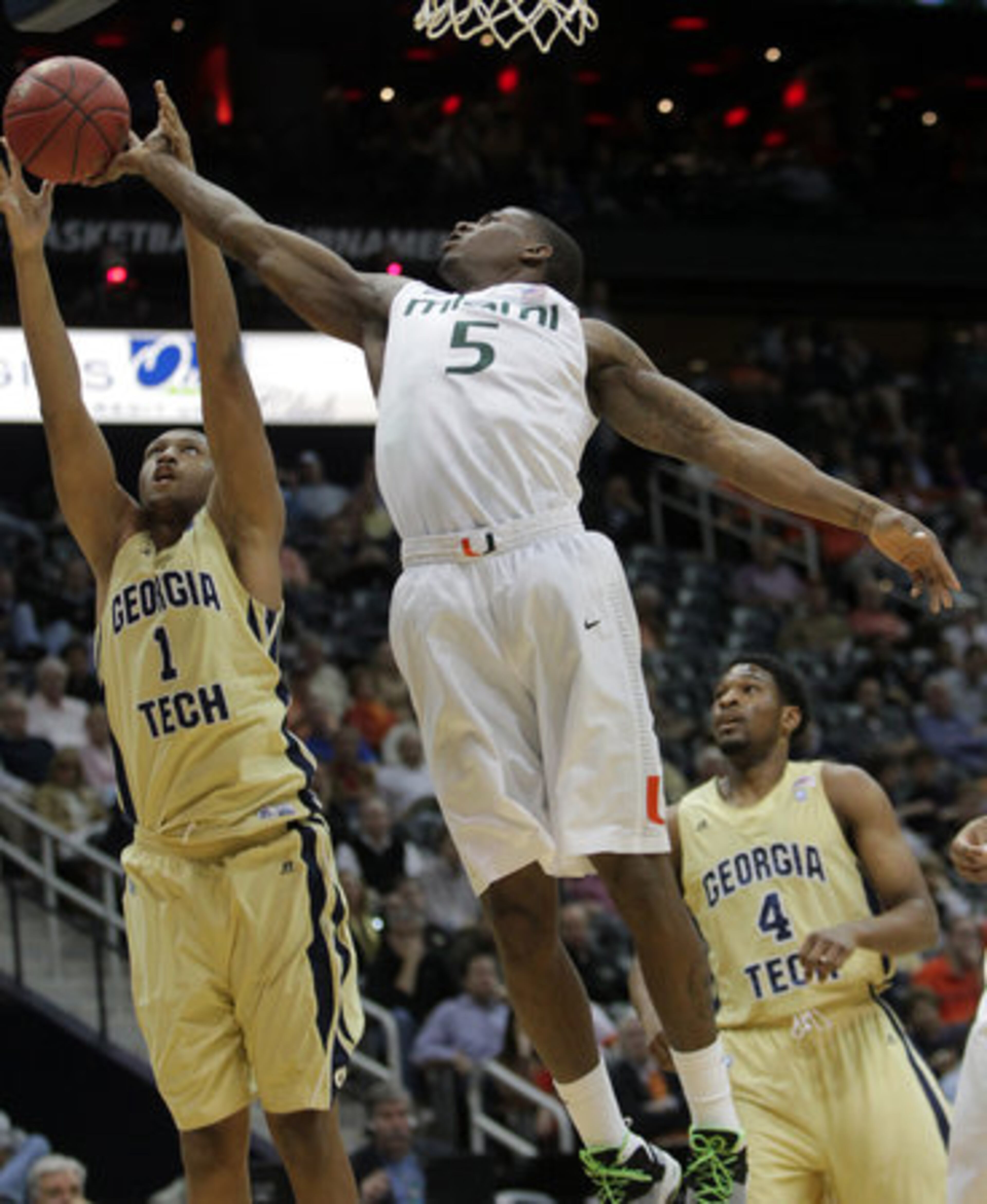 Miami Hurricanes DeQuan Jones knocks the rebound away from Georgia Tech Yellow Jackets Julian Royal in the ACC Tournament, Philips Arena, Thursday, March 8, 2012.