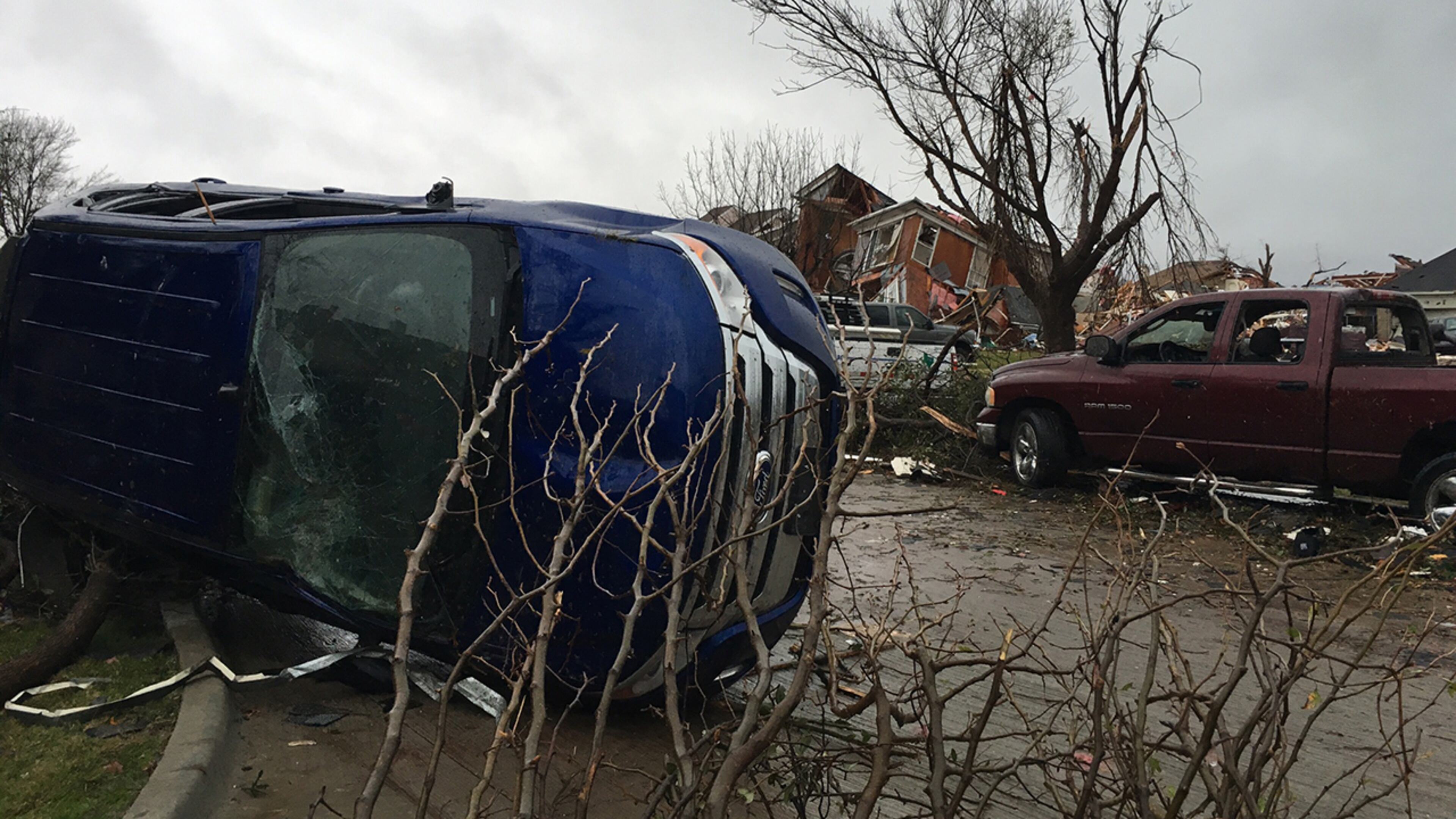 Damage of vehicles and houses are seen after Saturday's tornado spread out in Rowlett, Texas, Sunday, Dec. 27, 2015. At least 11 people died and dozens were injured in apparently strong tornadoes that swept through the Dallas area and caused substantial damage this weekend. (AP Photo/David Warren)