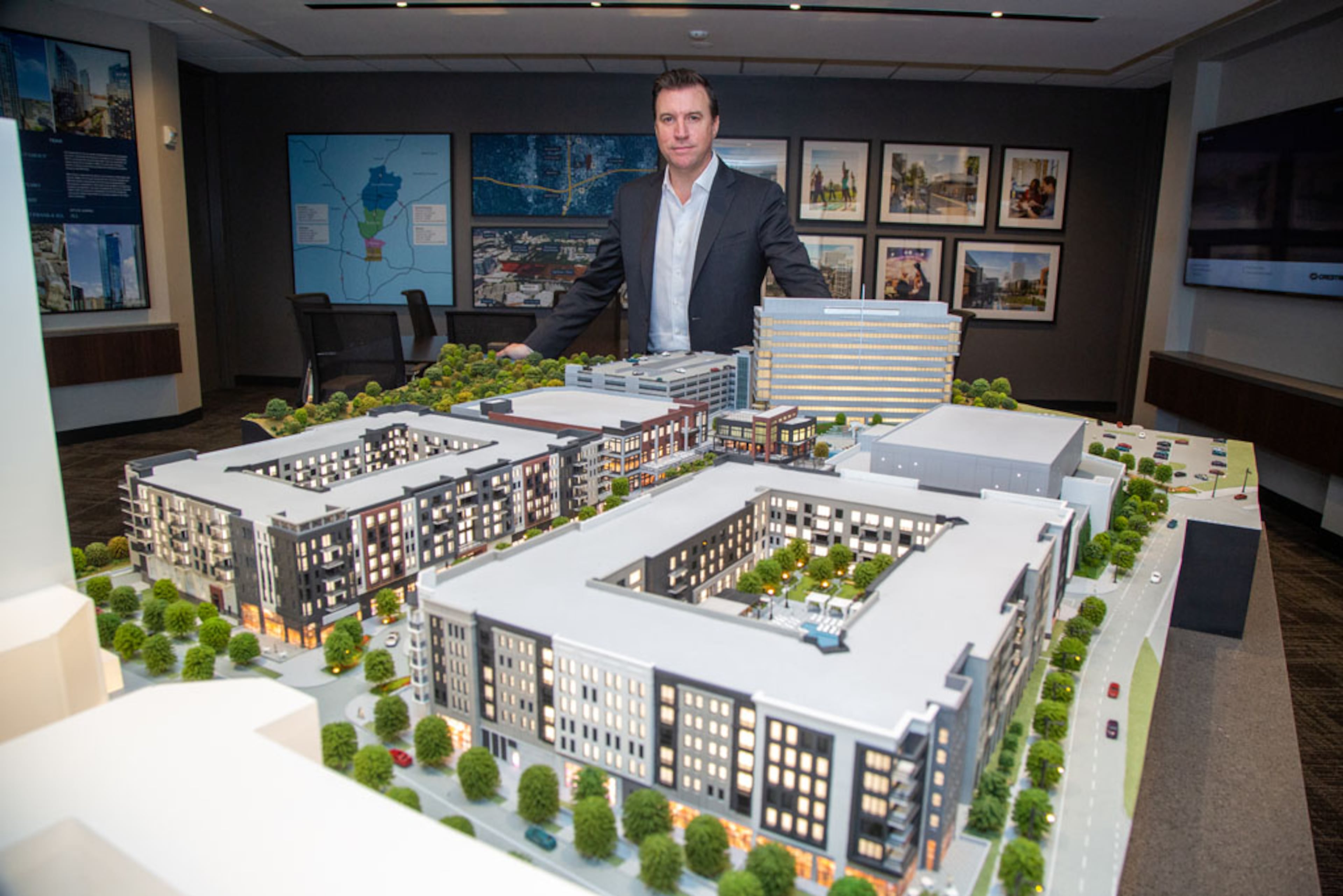 Portrait of GID Development President James Linsley with a 3D rendering of phase one of the High Street project at the Experience Center in Dunwoody. The idea for High Street proposed in Dunwoody has languished for more than 10 years, but construction is finally expected to start this year. The Boston-based developers recently got the required special land use and land disturbance permits from the city as the plans for High Street come into view a little more. They also got a tax break from the city's development authority. They hope for it to be like Avalon and the Battery - a retail, entertainment and office hub that would create a true "downtown" for the Perimeter Center area.. (Photo by Phil Skinner)