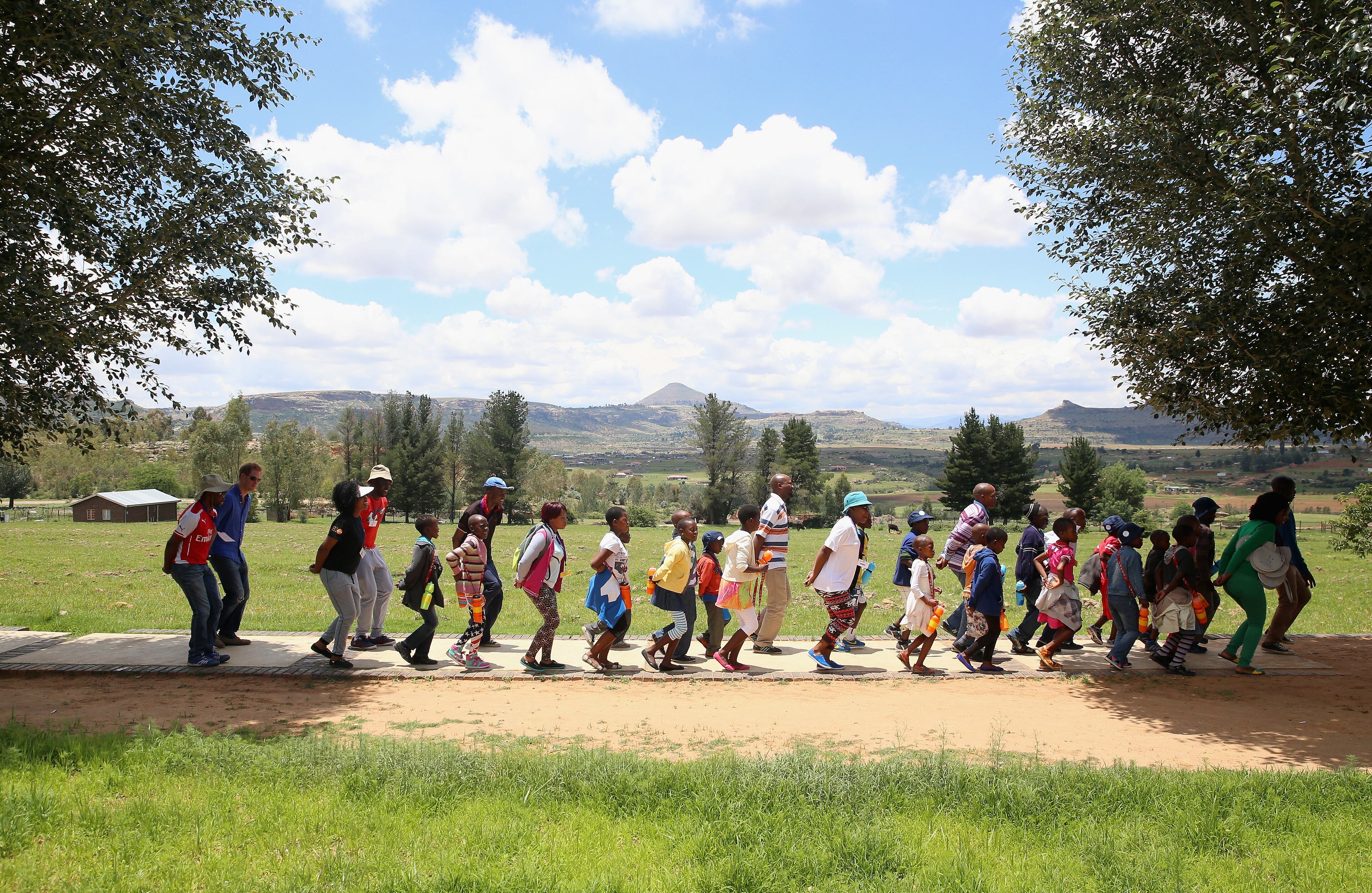 Prince Harry (L) joins in during a visit to a Mamohato Network Club for children living with HIV at St Paul Centre on December 9, 2014 in Maseru, Lesotho. Prince Harry was visiting Lesotho to see the work of his charity Sentebale. Sentebale provides healthcare and education to vulnerable children in Lesotho, Southern Africa. The particular theme of his visit was to check on the progress of the Mamohato Childrens Centre which will provide vital support to children affected by HIV. Prince Harry founded Sentebale (which means Forget Me Not in Sesotho) with Prince Seeiso in 2006. (Photo by Chris Jackson/Getty Images for Sentebale)