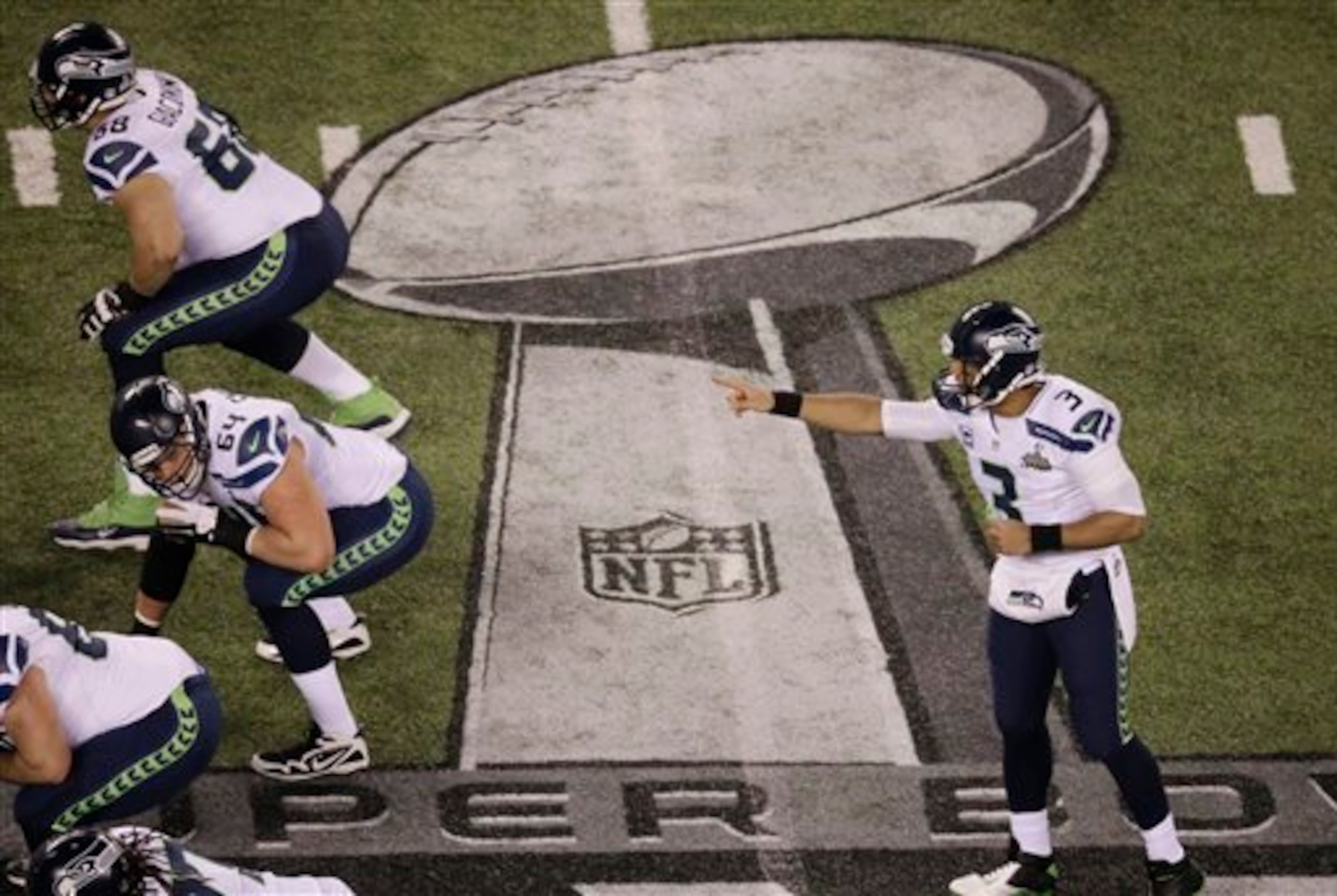 Seattle Seahawks' Russell Wilson works against the Denver Broncos during the first half of the NFL Super Bowl XLVIII football game Sunday, Feb. 2, 2014, in East Rutherford, N.J. (AP Photo/Mel Evans)