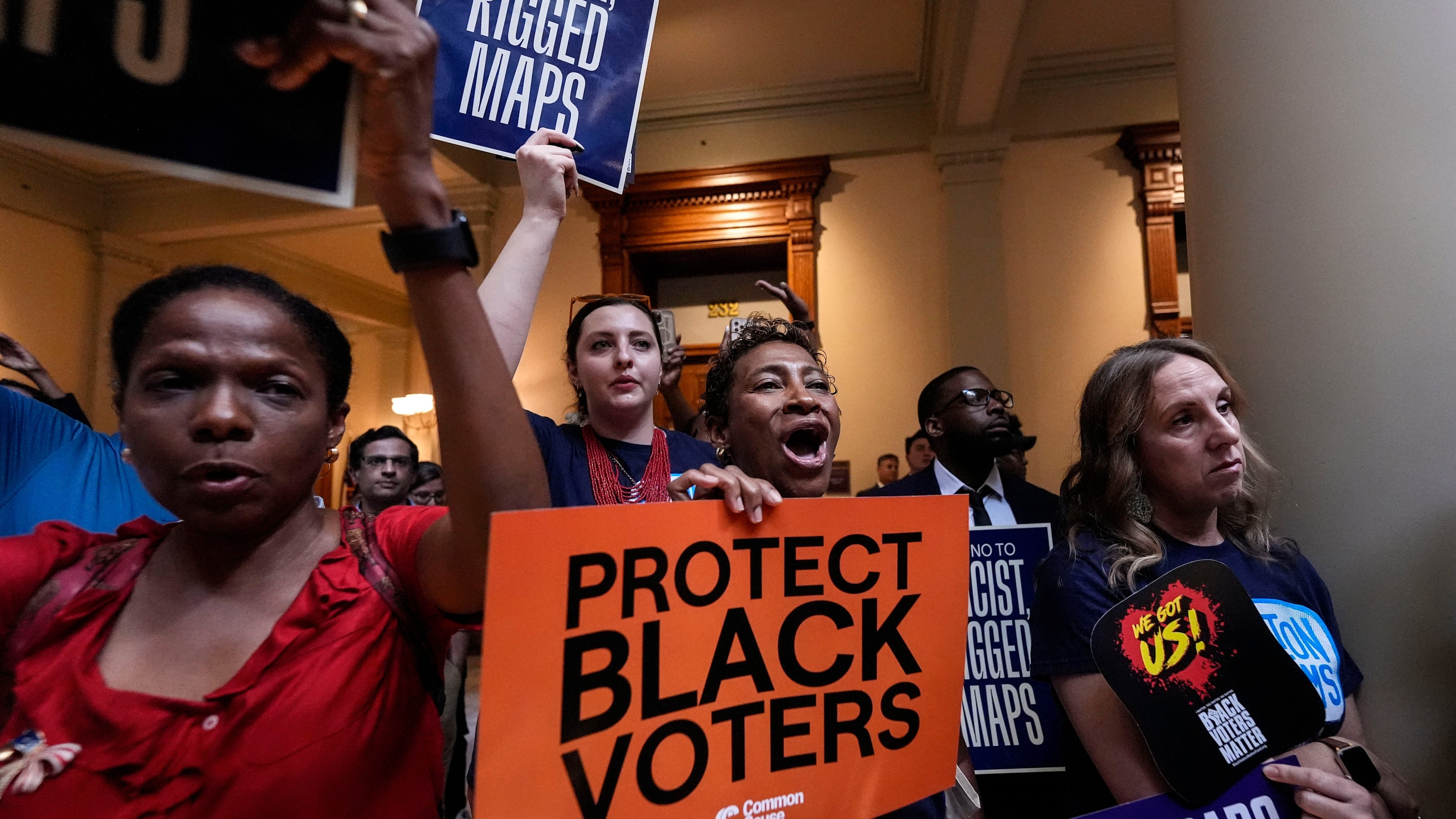 People listen and cheer as lawmakers speak about redistricting during a special legislative session at the state capitol, Wednesday, June 17, 2026, in Atlanta. (AP Photo/Mike Stewart)