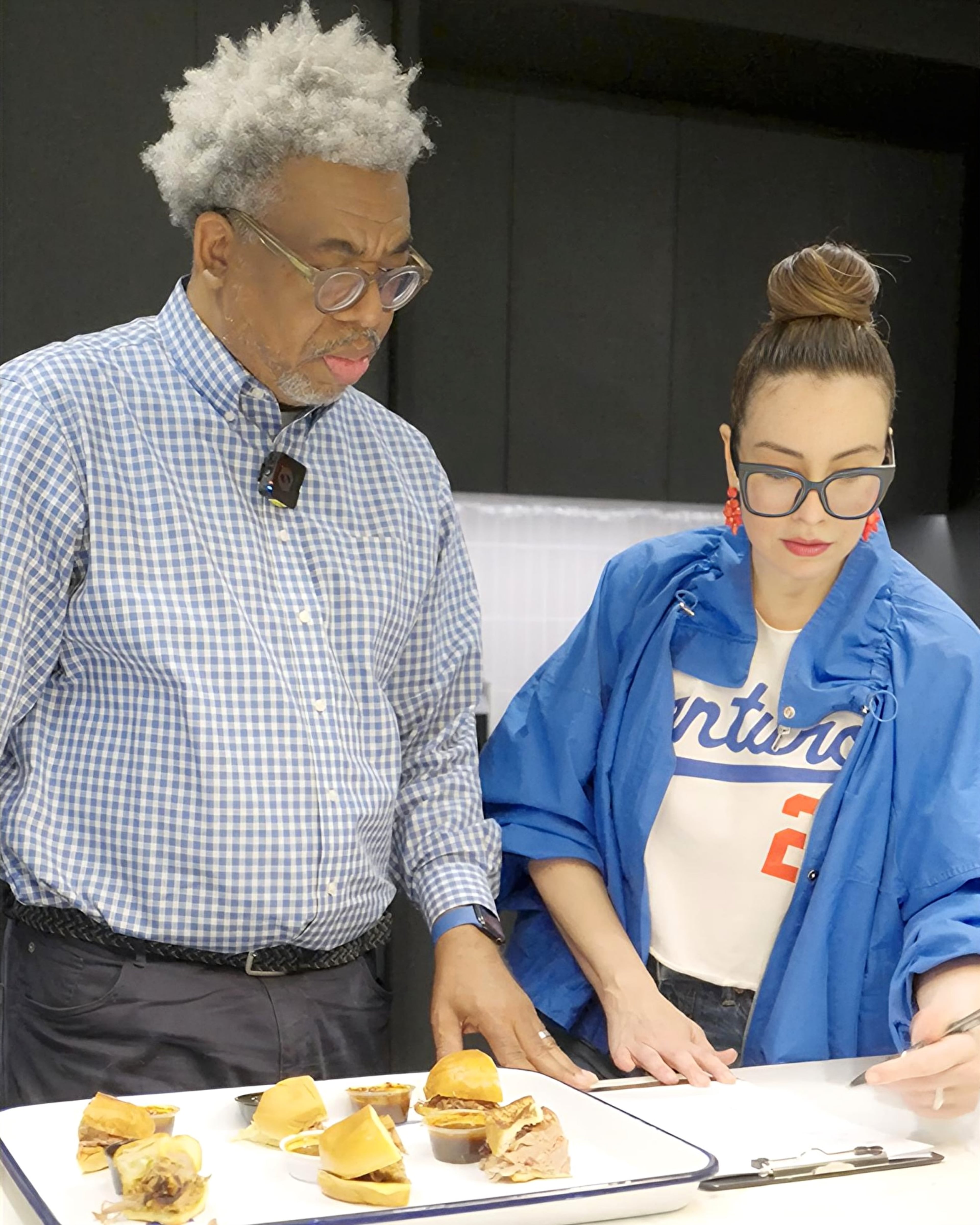 UATL Senior Editor Ernie Suggs (left) and Food & Dining Senior Editor Monti Carlo (right) prepare for the AJC's Best Pulled Pork Sandwich in Atlanta taste test. (Ellen Rolfe/AJC)