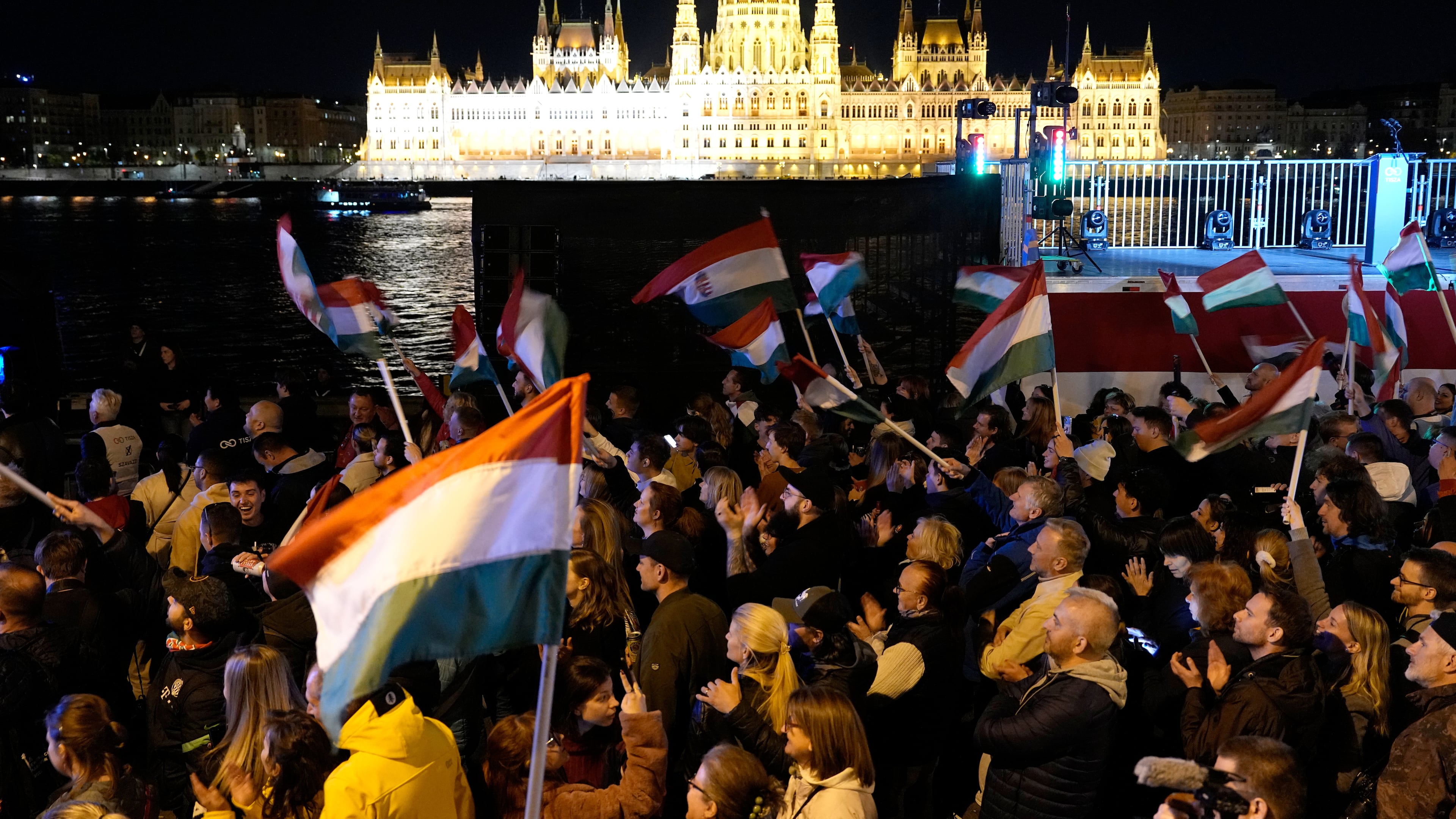 Supporters of Peter Magyar, the leader of the opposition Tisza party celebrates after a parliamentary election in Budapest, Hungary, Sunday, April 12, 2026. (AP Photo/Darko Bandic)