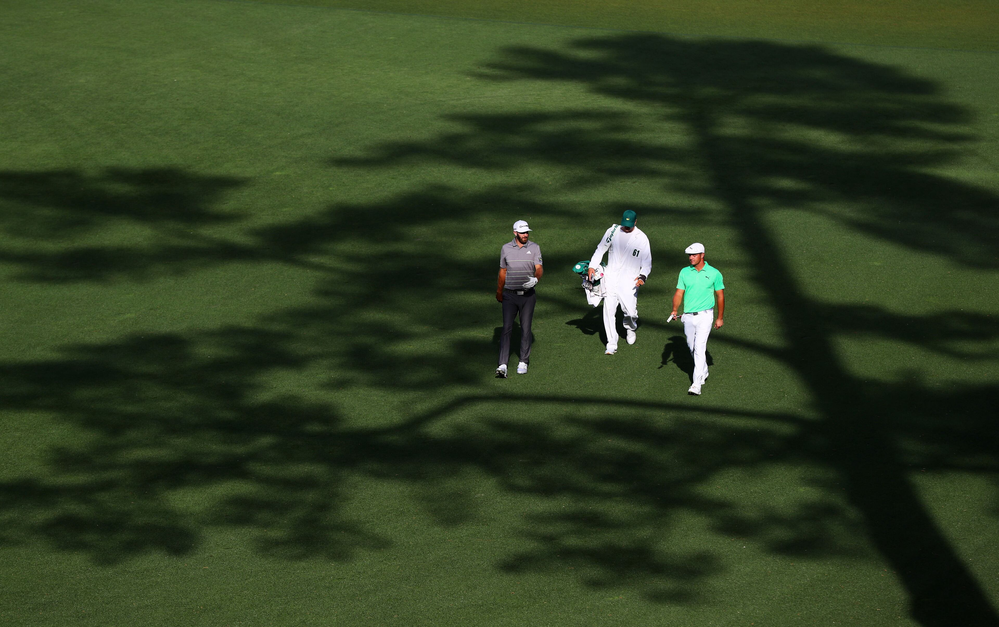 April 11, 2019 - Augusta - Dustin Johnson and Bryson DeChambeau on the 15th fairway during the first round of the Masters Tournament Thursday, April 11, 2019, at Augusta National Golf Club in Augusta. Curtis Compton / ccompton@ajc.com