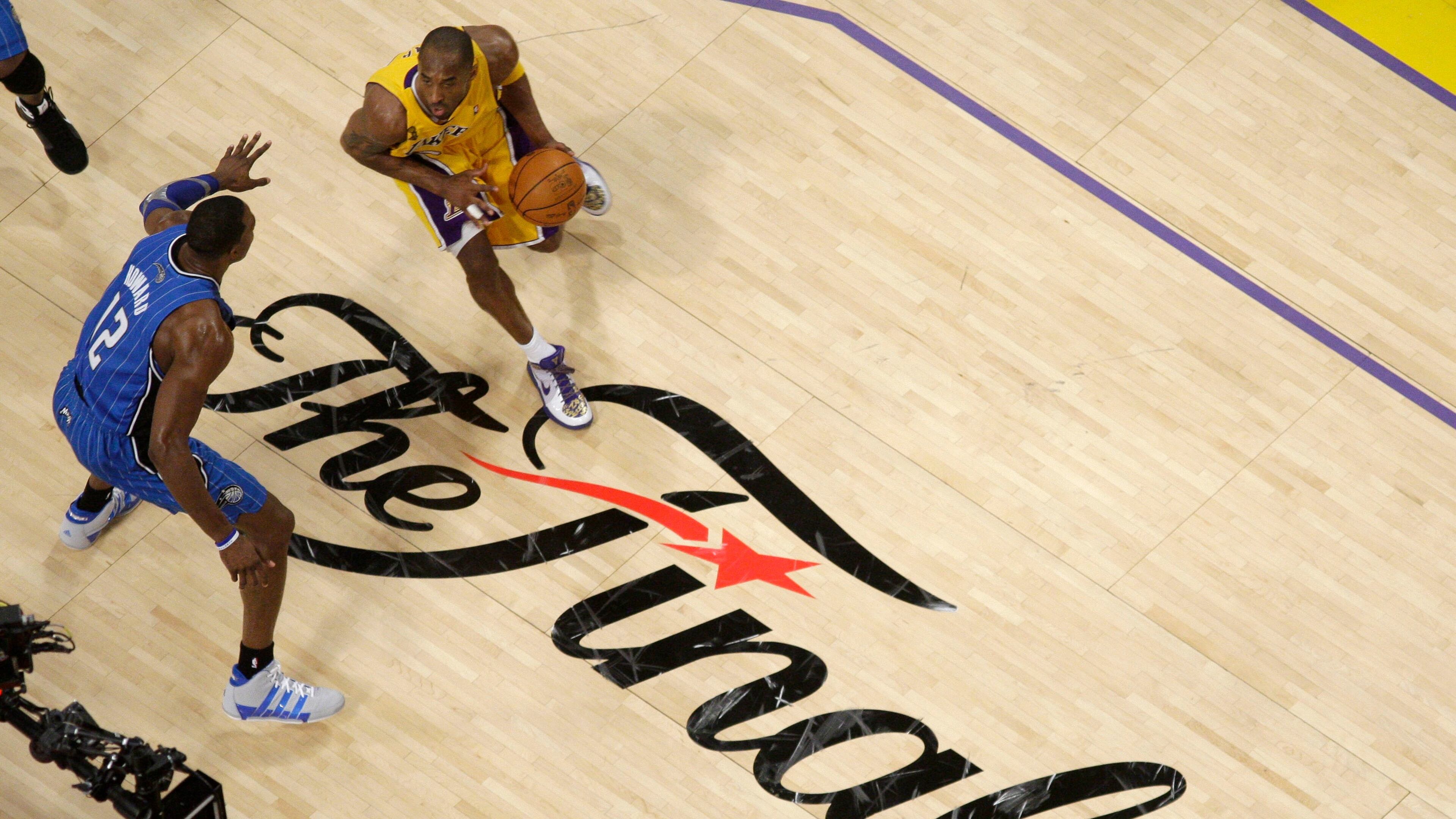 FILE - Los Angeles Lakers guard Kobe Bryant dribbles as Orlando Magic center Dwight Howard defends during the second half of Game 1 of the NBA basketball finals June 4, 2009, in Los Angeles. (AP Photo/Mark J. Terrill, File)