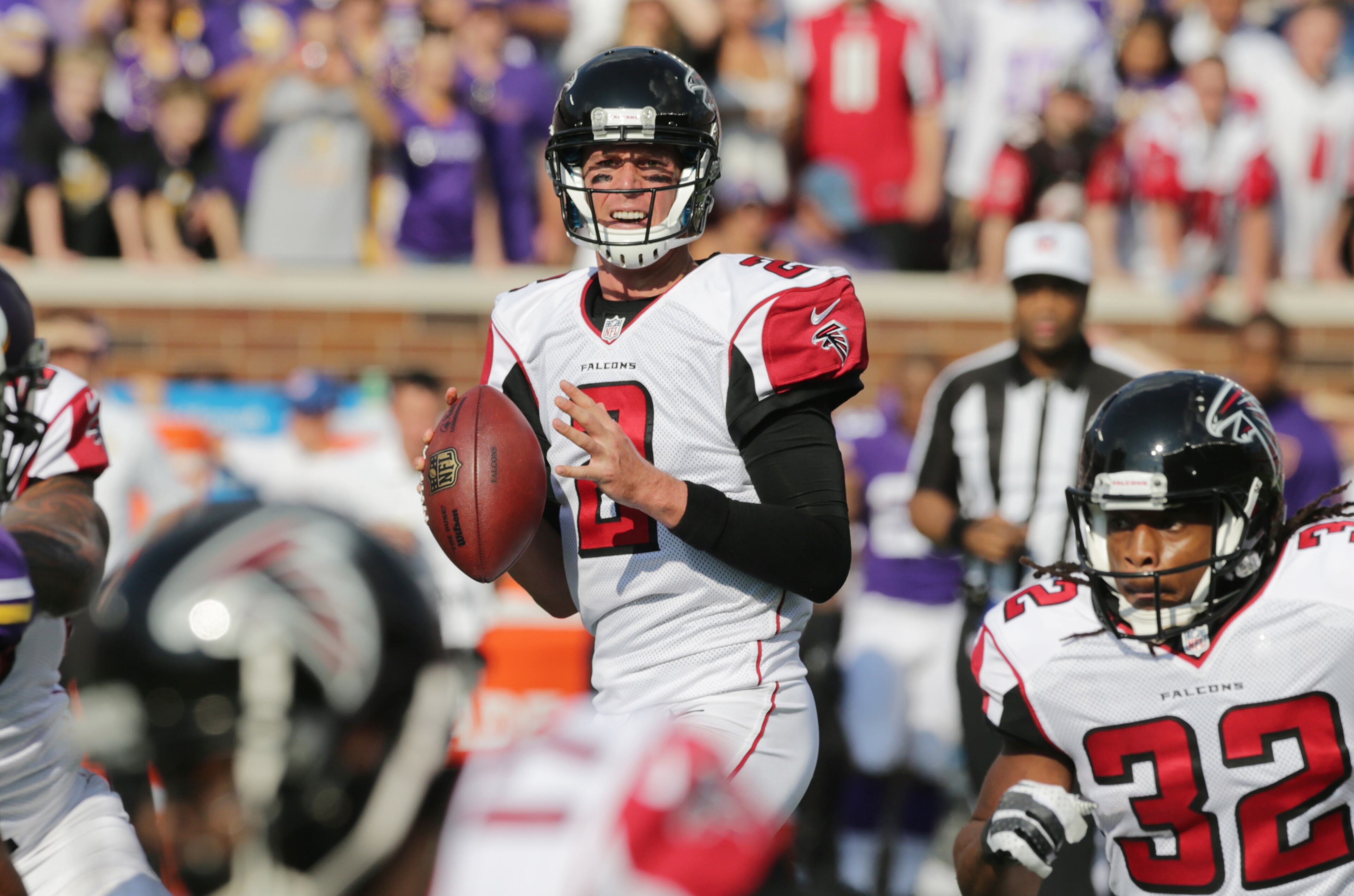 Atlanta Falcons quarterback Matt Ryan, center, looks to pass during the first half of an NFL football game against the Minnesota Vikings, Sunday, Sept. 28, 2014, in Minneapolis. (AP Photo/Jim Mone)
