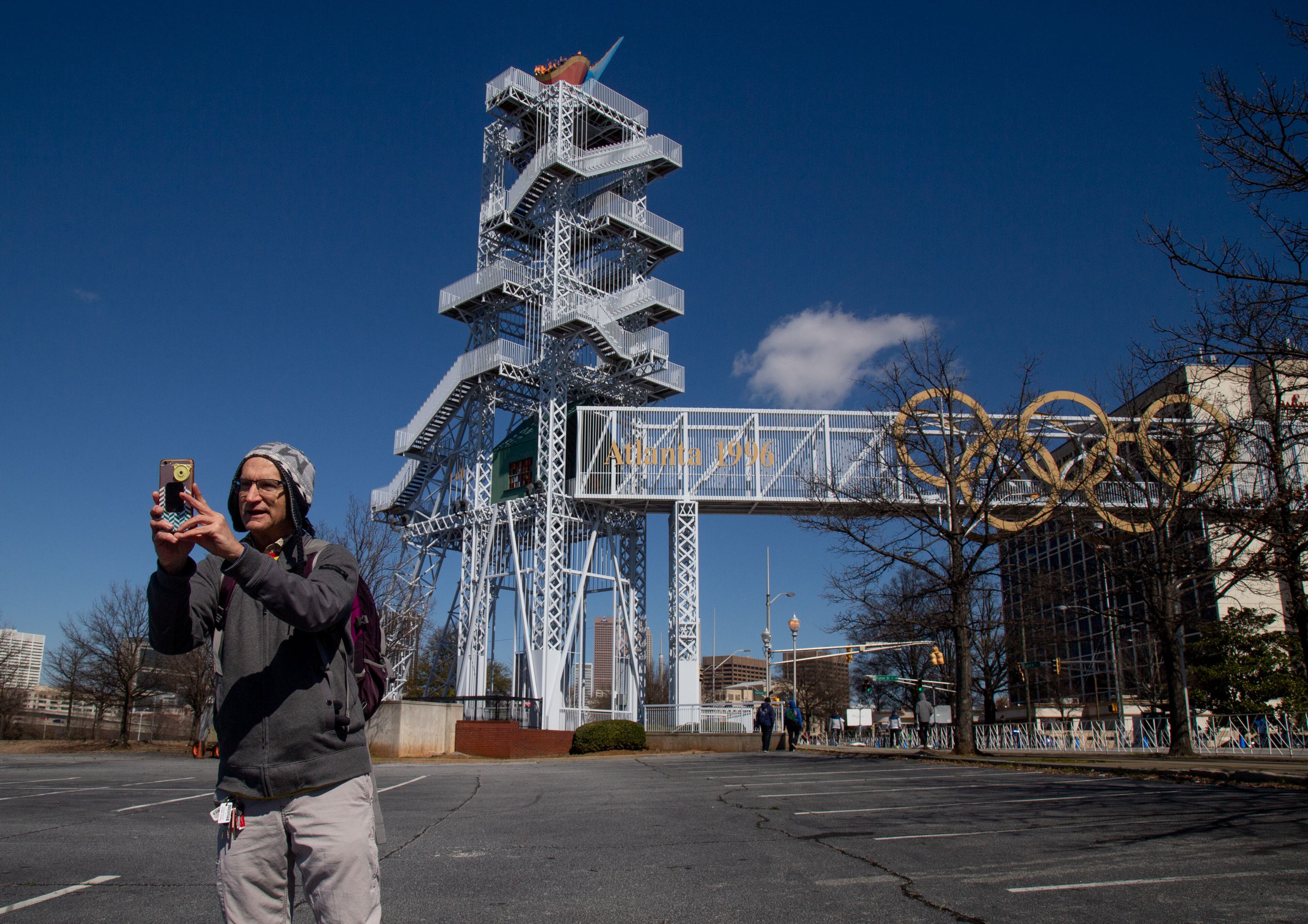 Miguel Toral takes a selfie in front of the Olympic cauldron reignited for the U.S. Olympic Team marathon trials in Atlanta on Saturday, February 29, 2020. STEVE SCHAEFER / SPECIAL TO THE AJC