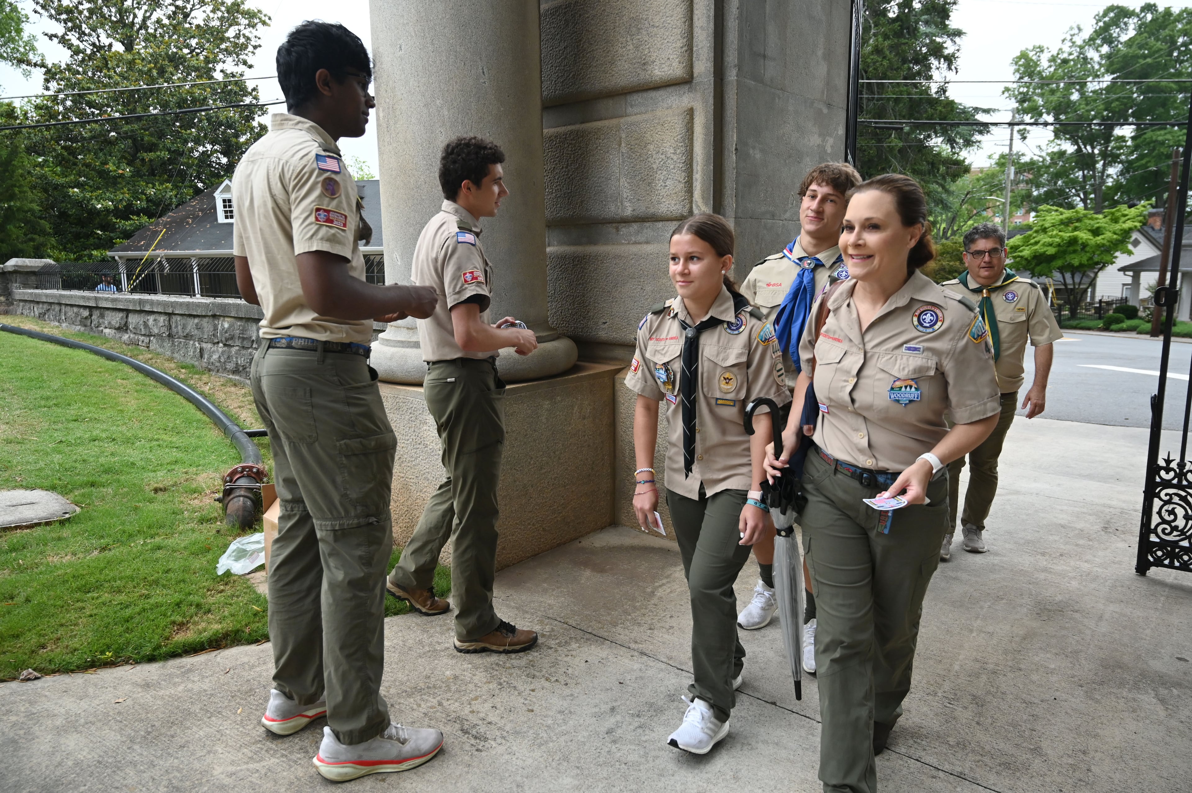 Scouts and leaders arrive for the Memorial Day Flag Placement event at Marietta National Cemetery on Saturday, May 23, 2026, in Marietta. Scouting groups in the community place more than 18,000 U.S. veteran grave flags at Marietta National Cemetery each year on the Saturday before Memorial Day, helping prepare for Monday’s ceremony. The long-running service project—organized with the National Memorial Day Association of Georgia—also gives youth and adults an opportunity to honor fallen service members and learn about their sacrifices and the area’s history. (Hyosub Shin/AJC)