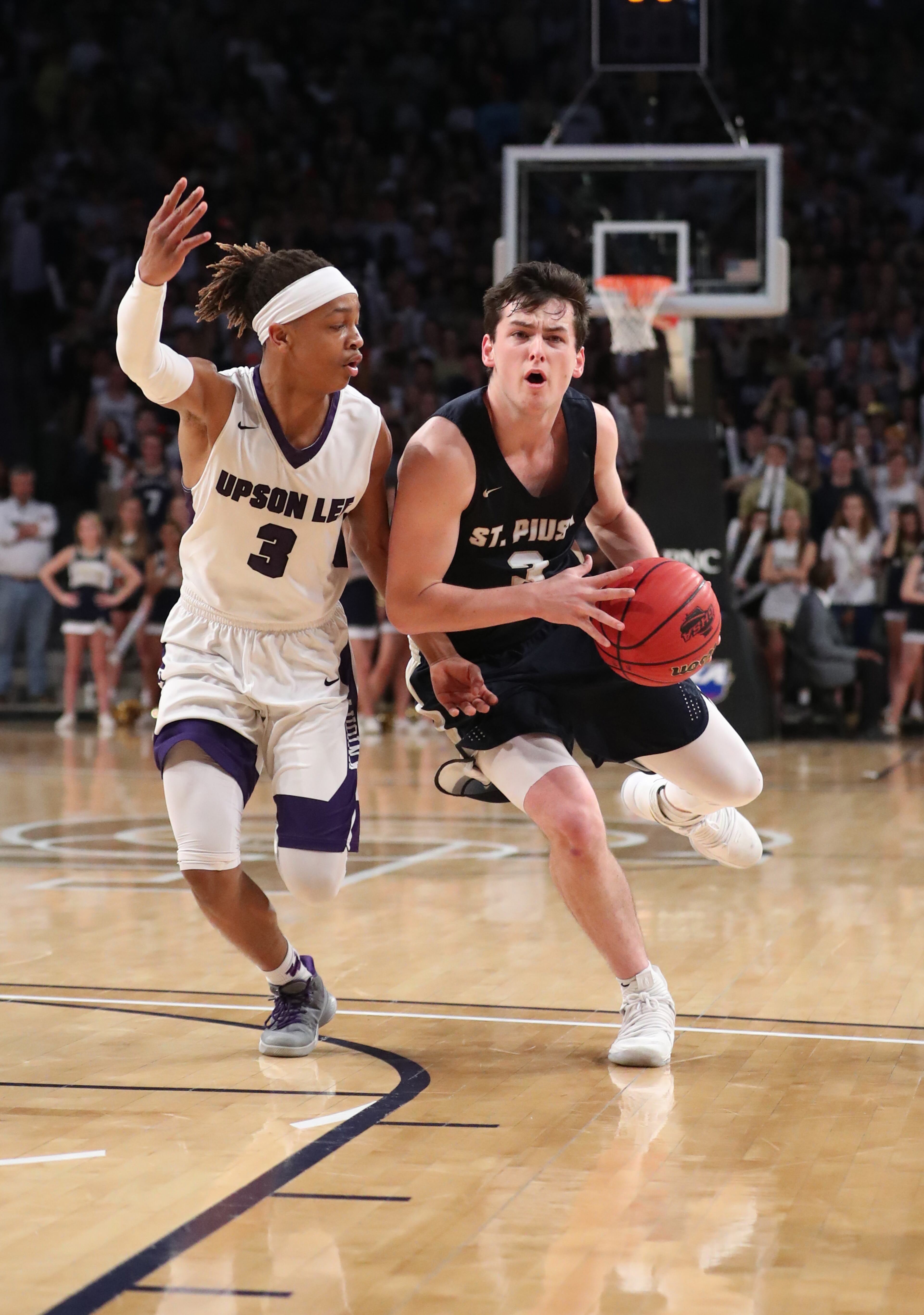 March 10, 2018 - Atlanta, Ga: St. Pius guard Everett Lane (3) drives against Upson-Lee guard Zyrice Scott (3) during the first half of the GHSA Class AAAA Boys State Championship at McCamish Pavilion Saturday, March 10, 2018, in Atlanta. PHOTO / JASON GETZ