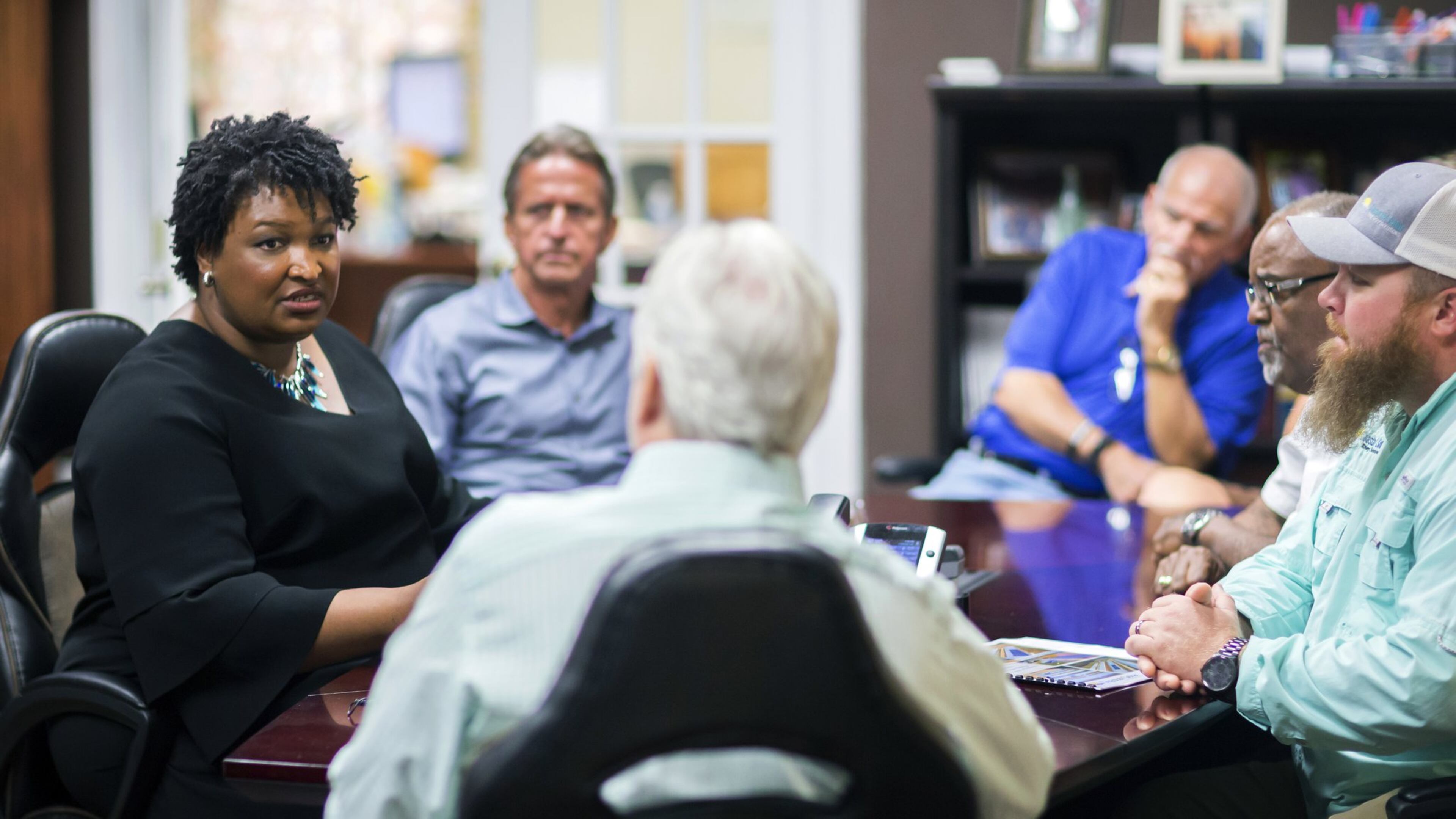 Georgia Democratic gubernatorial candidate Stacey Abrams, left, meets with a group of employees at the Coastal Solar office in Hinesville. Abrams has scored a fundraising success with more than 31,000 donations of less than $100, account for about $1.3 million. But much of that haul has come from outside the state, giving Republicans an issue in the race. (AP Photo/Stephen B. Morton)