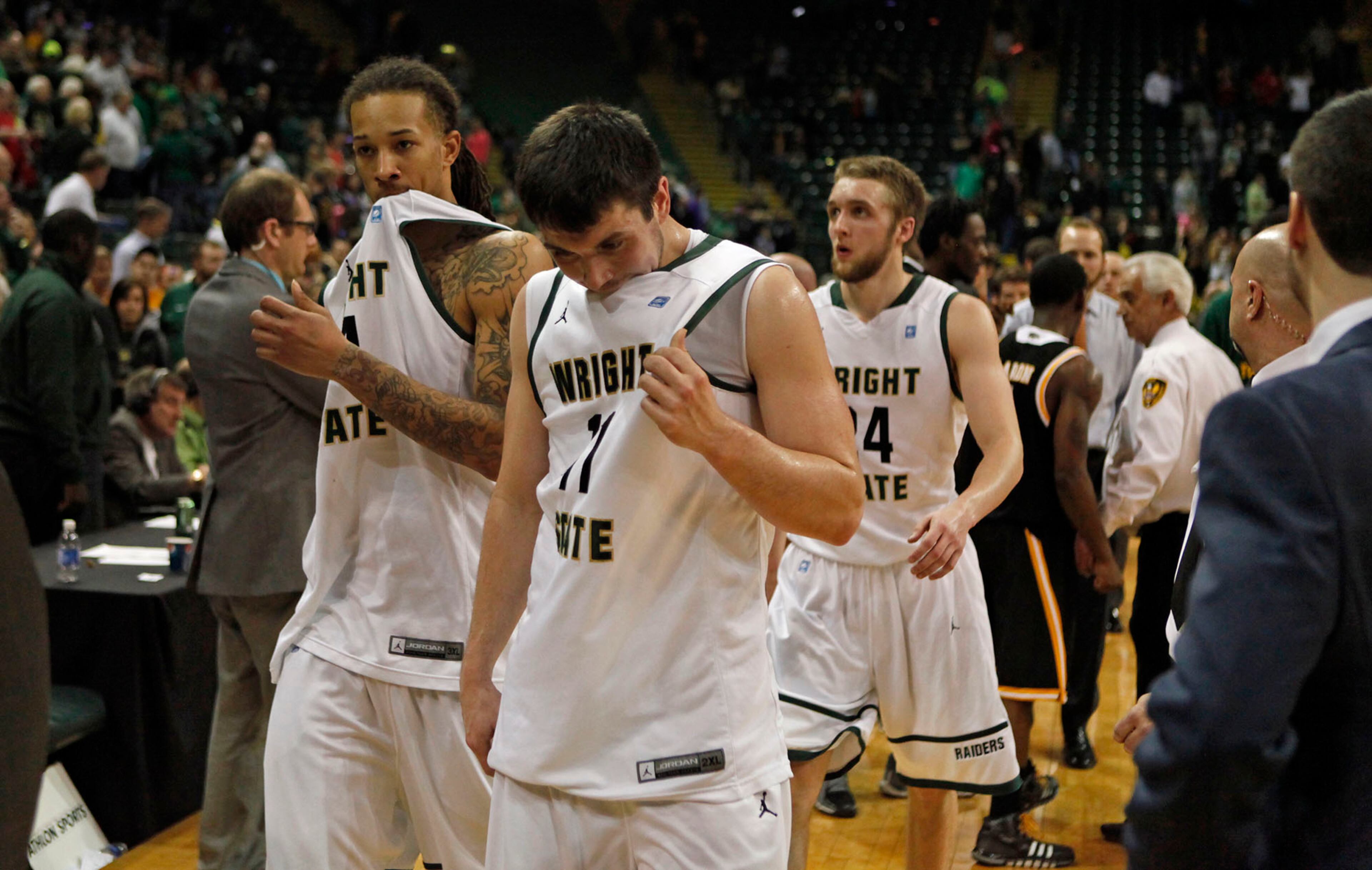 Defeated Wright State Raiders leave the court after losing to the Milwaukee Panthers 69-63 for the Horizon League Championship. TY GREENLEES / STAFF