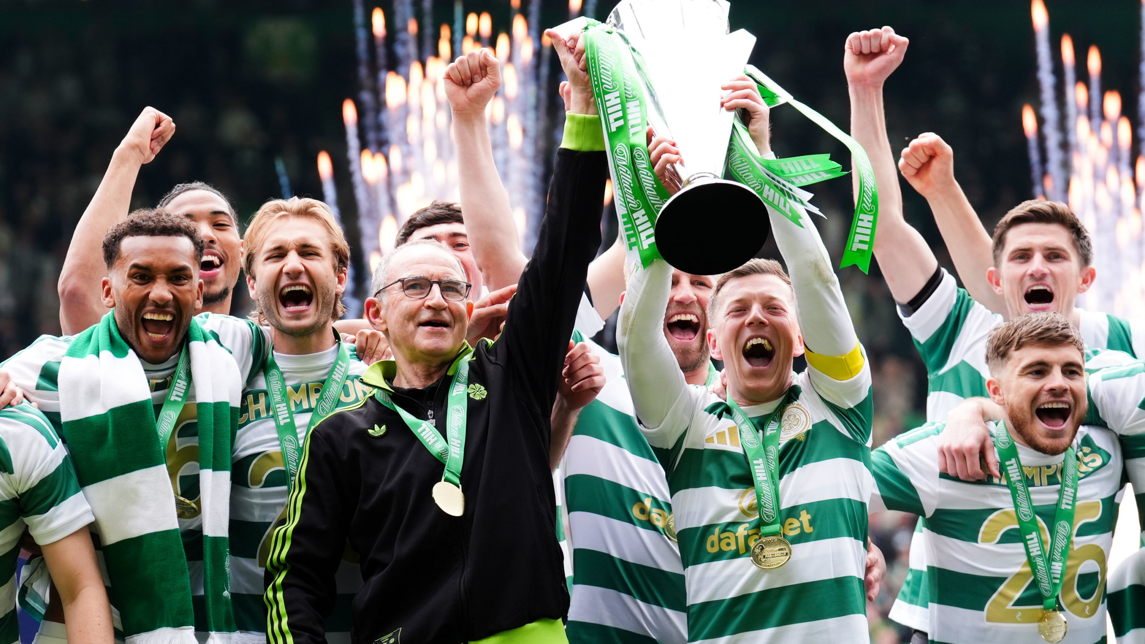 Celtic manager Martin O'Neill and Callum McGregor hold the Scottish Premier League Trophy following his side's title deciding match against Heart of Midlothian at Celtic Park, in Glasgow, Scotland, Saturday May 16, 2026. (Andrew Milligan/PA via AP)