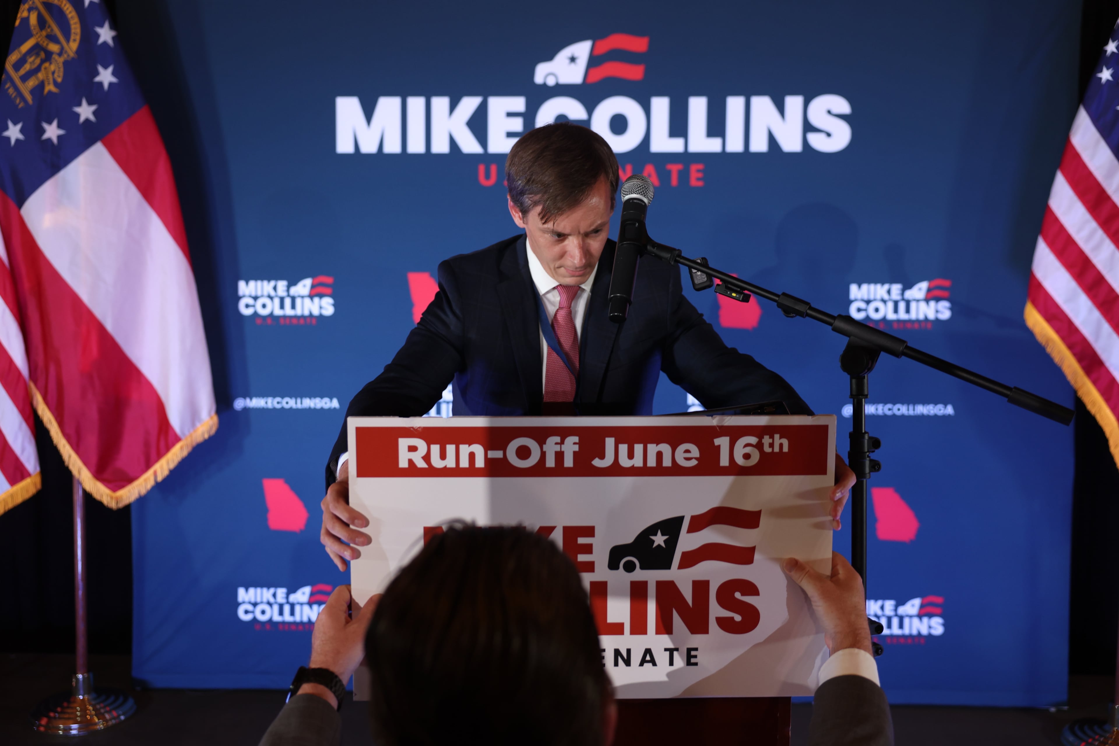 Brandon Phillips, consultant for Republican U.S. Senate candidate Mike Collins, places a sign during Collins’ primary election watch party at The Carmichael House in Jackson on May 19, 2026. (Arvin Temkar/AJC)