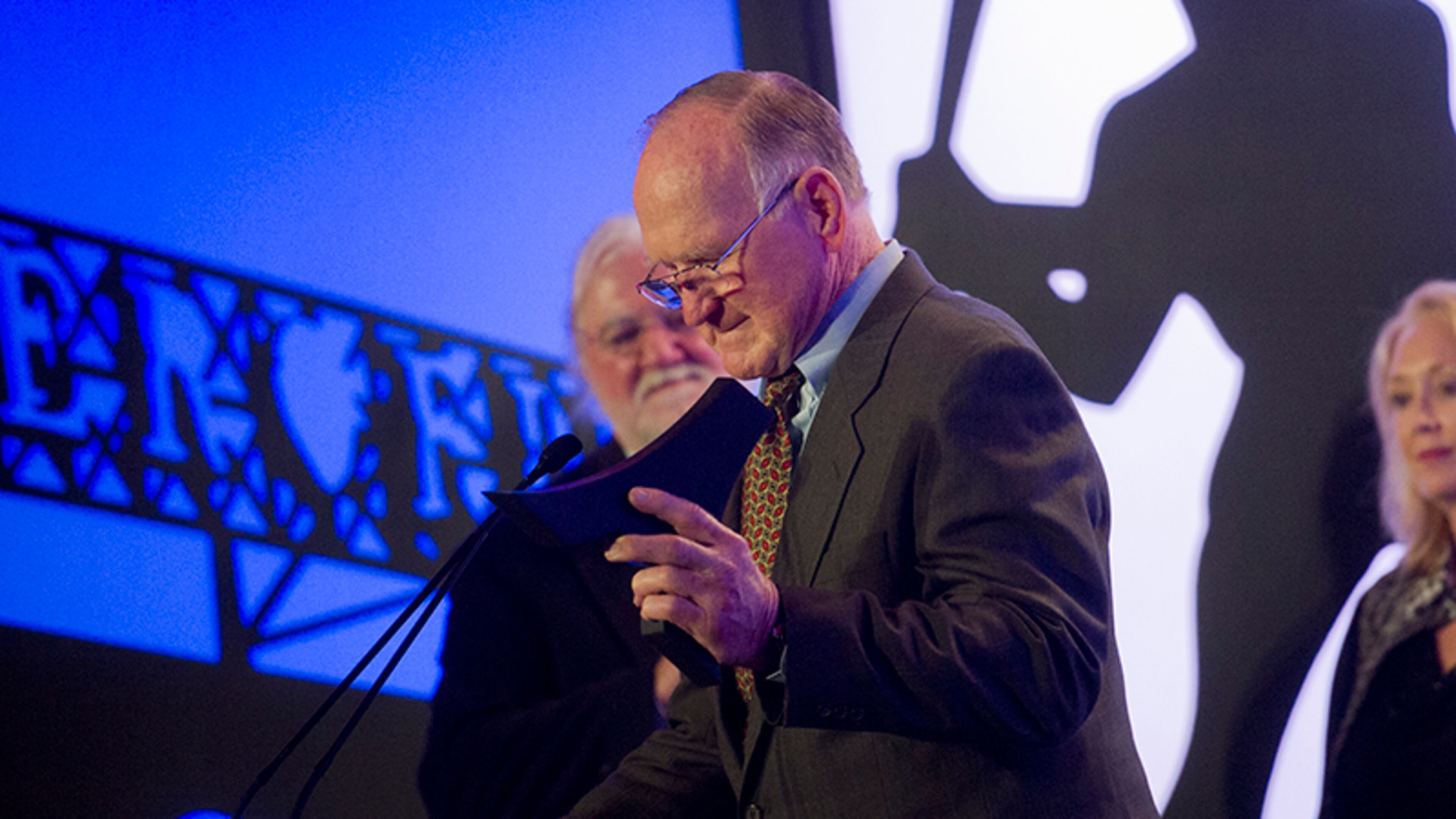 Tommy Nobis (center) is presented the 2014 Lifetime Achievement Award during the ninth annual Atlanta Sports Awards Wednesday at the Fox Theatre.