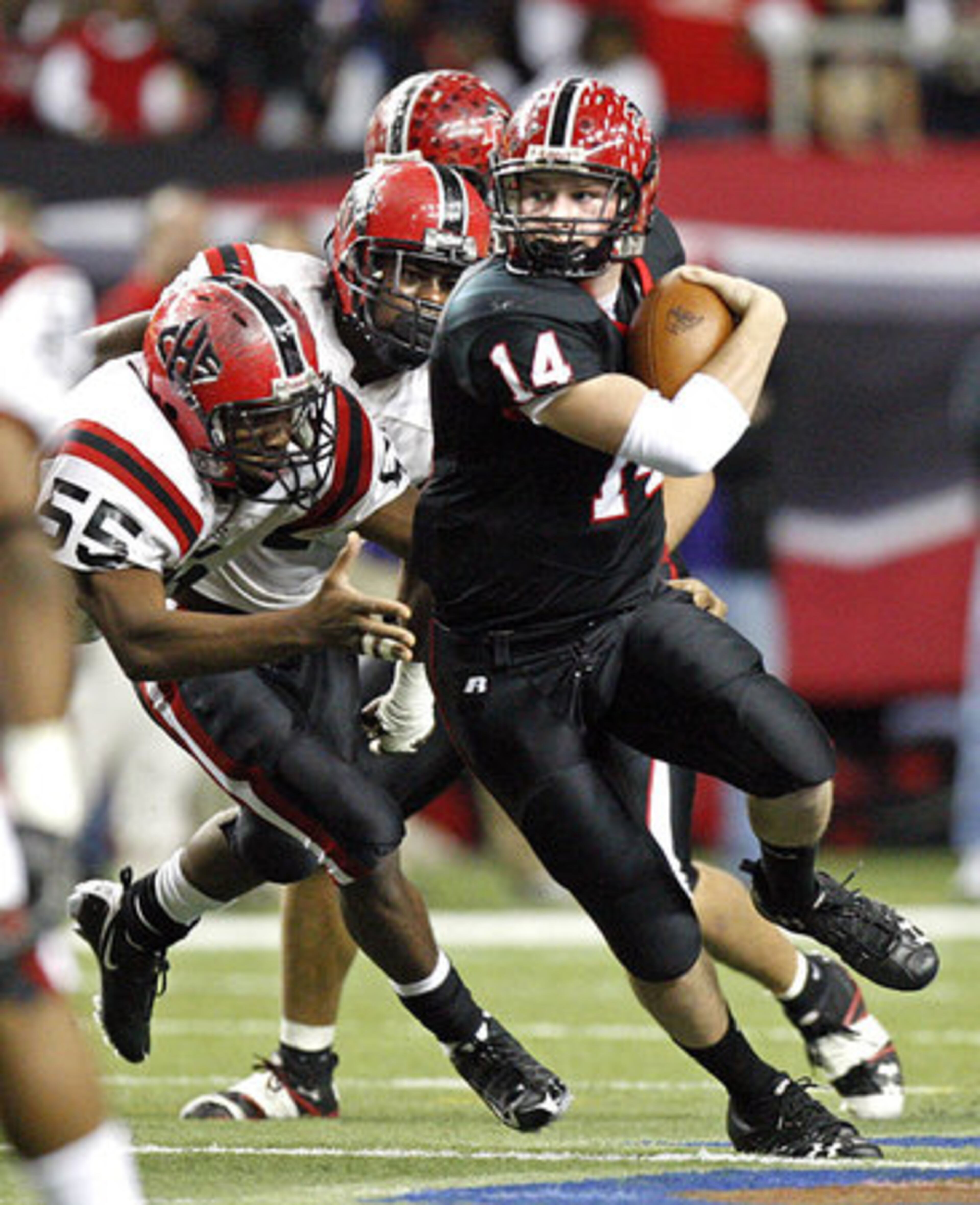 Flowery Branch quarterback Connor Shaw (14) gets by the defense of Cairo's Anthony Brown (55) and Logan Bennett (4).