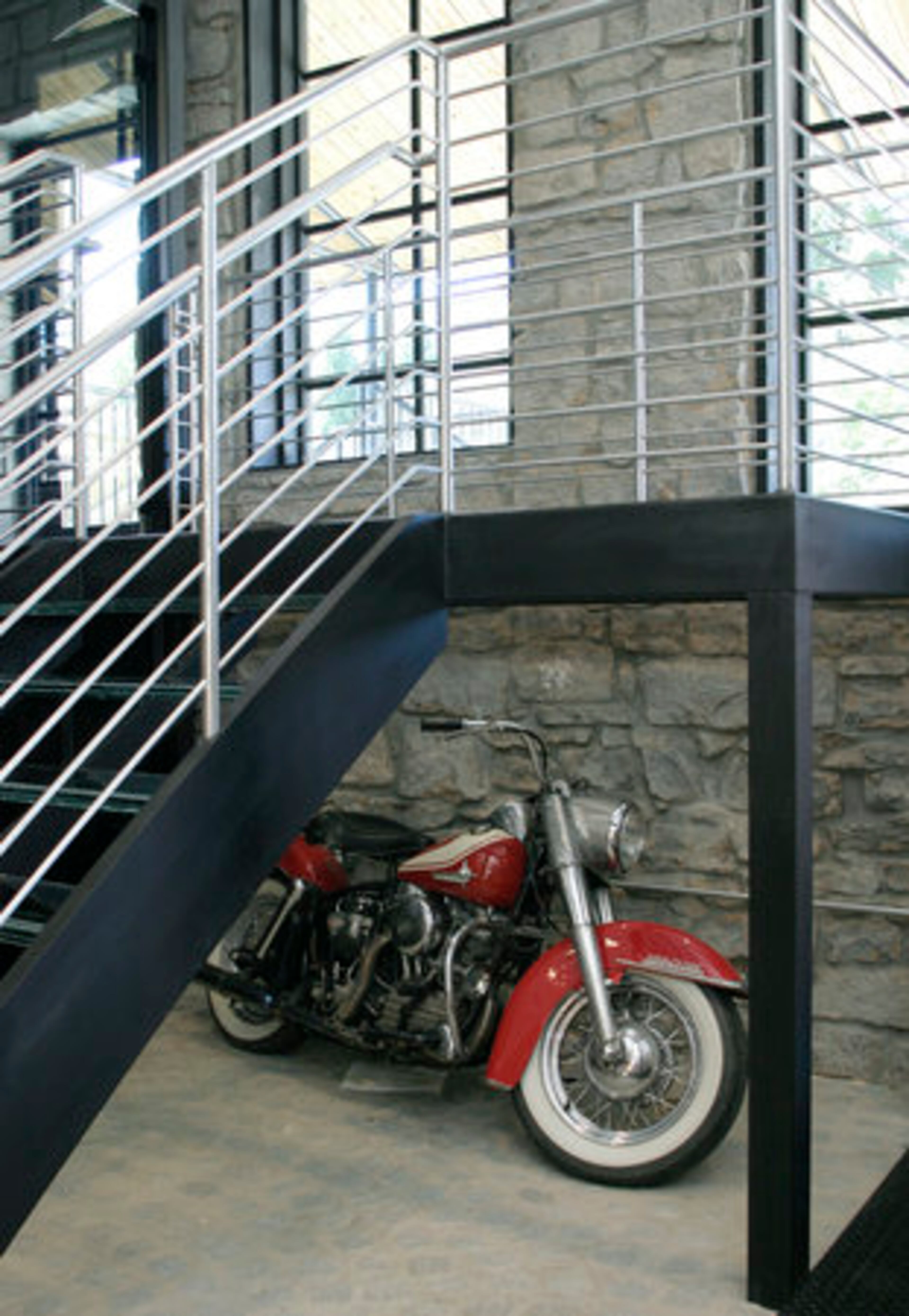 A vintage Harley-Davidson rests beneath the staircase. Besharat said he bought it "to show off."