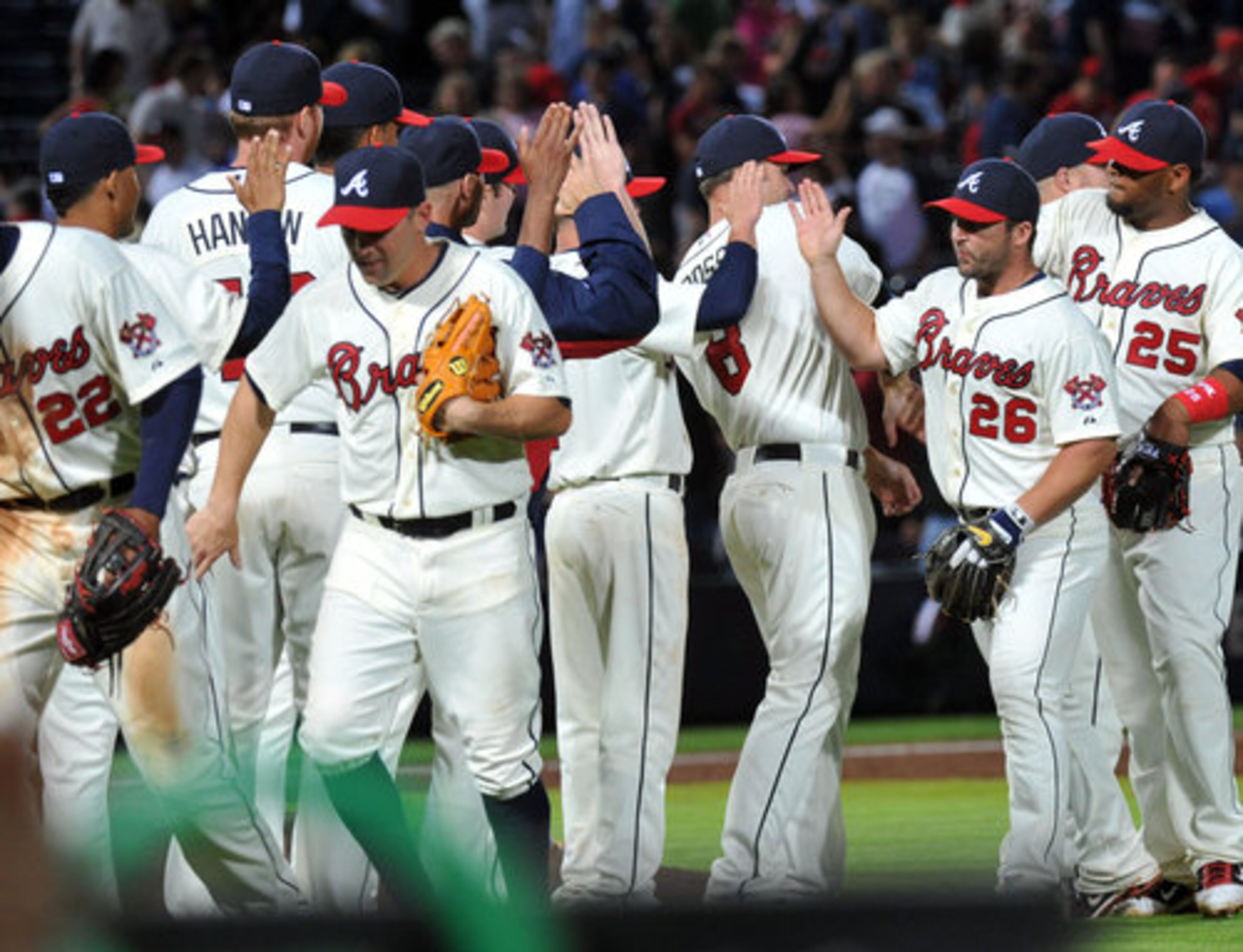 Atlanta Braves players celebrate their 2-1 win over the Milwaukee Brewers at Turner Field in Atlanta on Saturday, April 14, 2012.