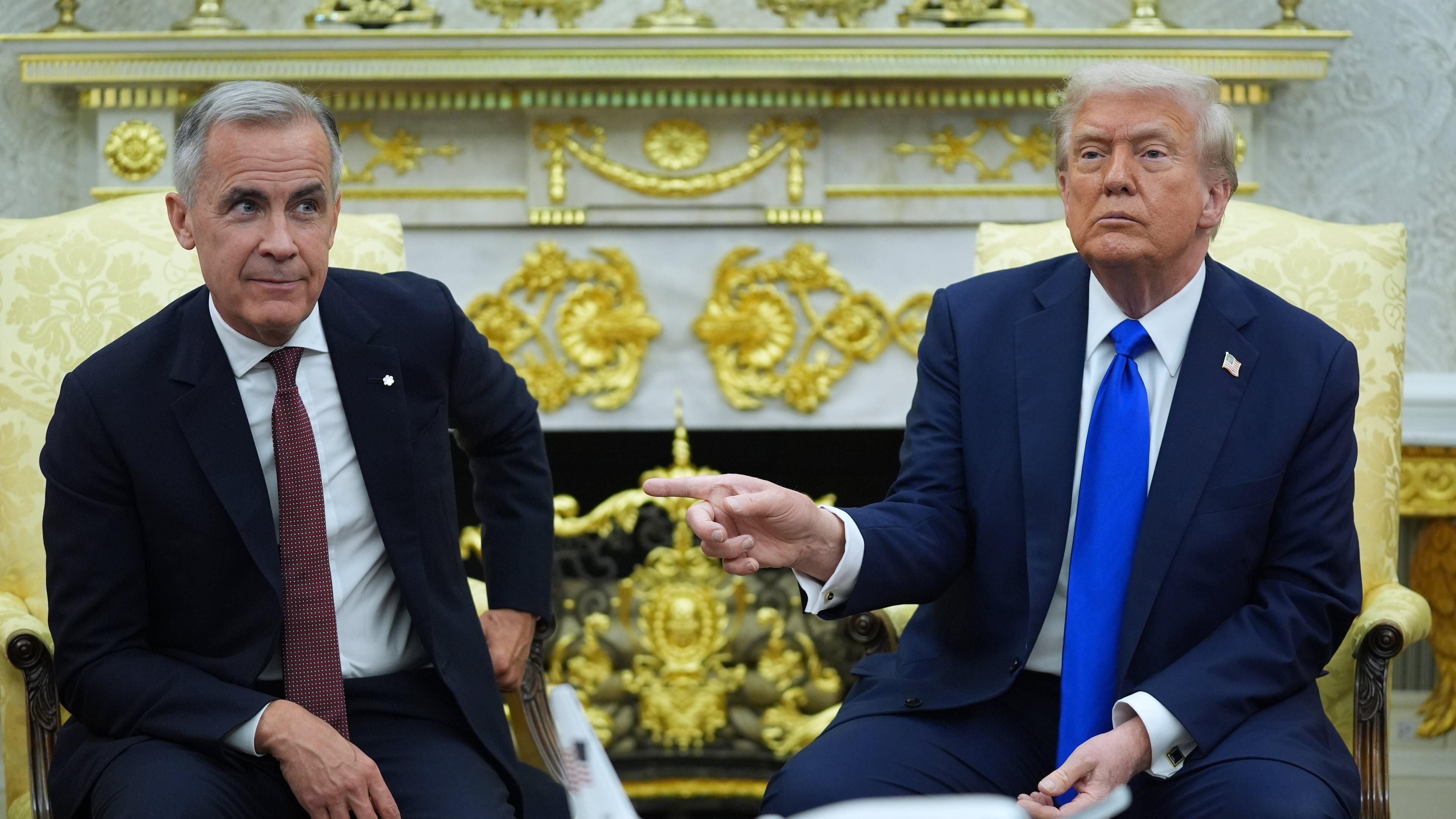 FILE - President Donald Trump gestures alongside Canadian Prime Minister Mark Carney as they meet in the Oval Office of the White House, Oct. 7, 2025, in Washington. (AP Photo/Evan Vucci, File)