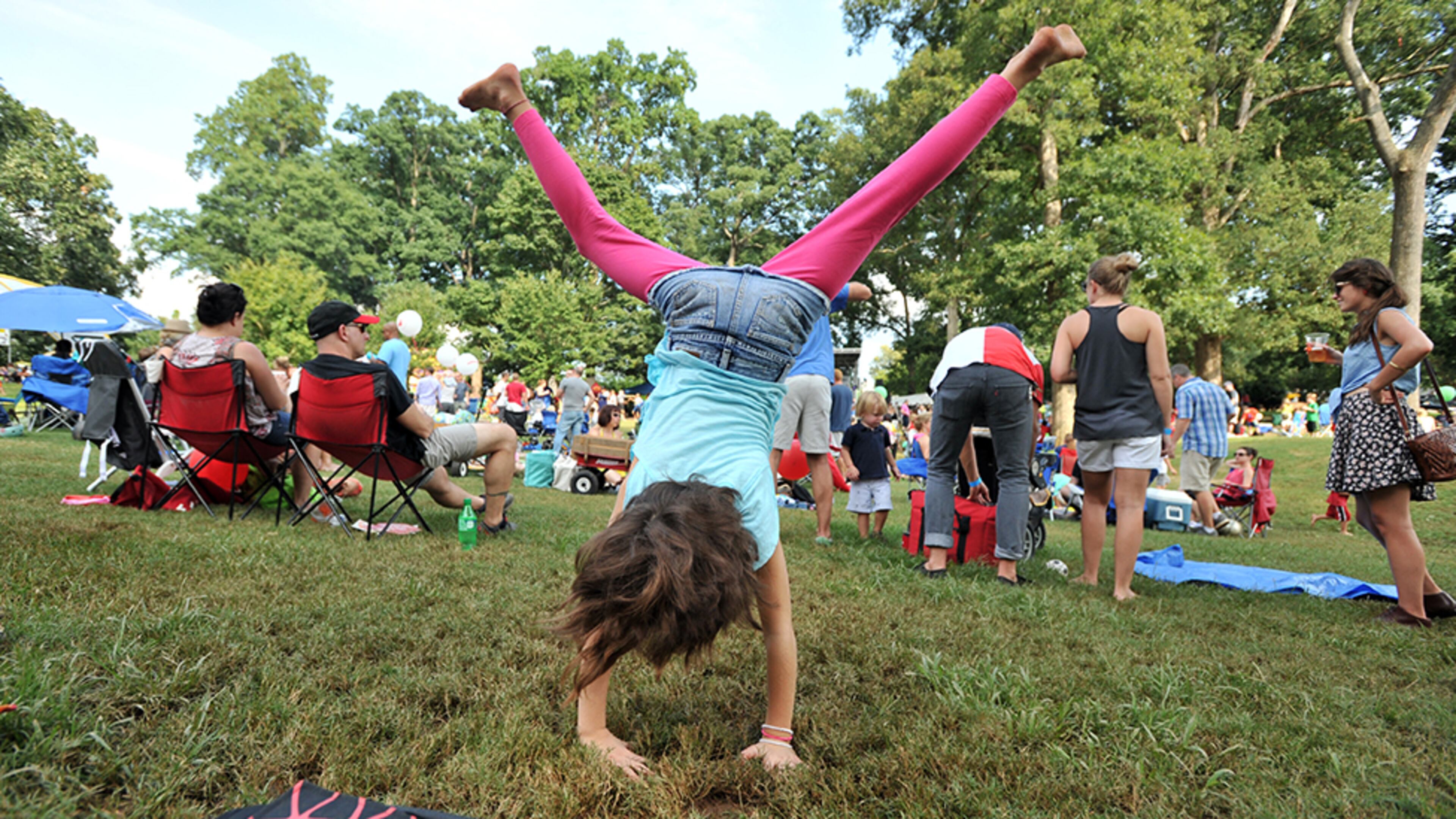 Shannon Smith, 7, tumbles on the grass during Grant Park Summer Shade Festival on Saturday, August 24, 2013. HYOSUB SHIN / HSHIN@AJC.COM