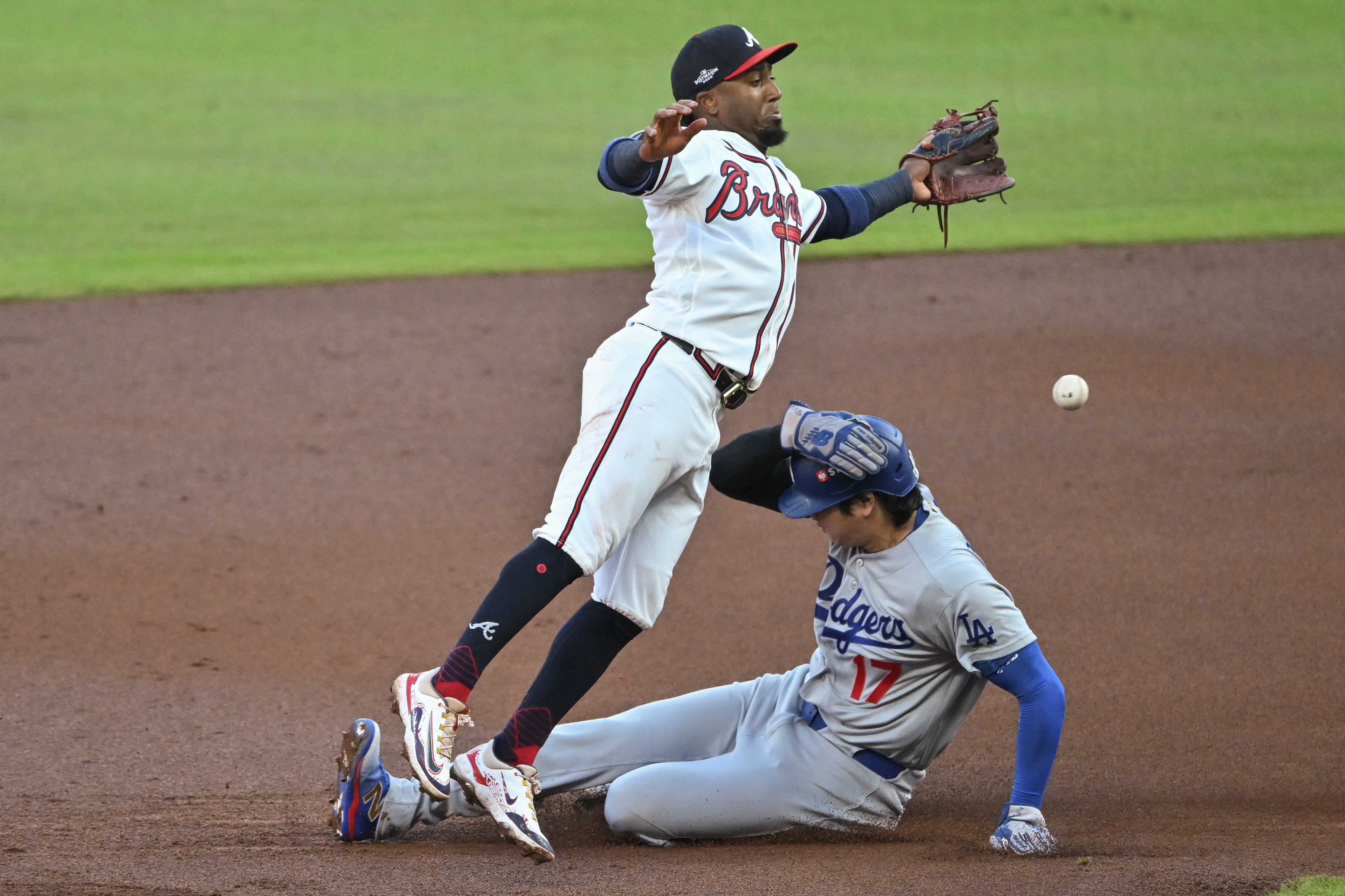 Los Angeles Dodgers designated hitter Shohei Ohtani (17) steals second base against Atlanta Braves second baseman Ozzie Albies (1) during the second inning of Game 4 of the MLB National League Division Series between the Atlanta Braves and the Los Angeles Dodgers, Wednesday, Oct. 7, 2026, in Atlanta. (Hyosub Shin/AJC)