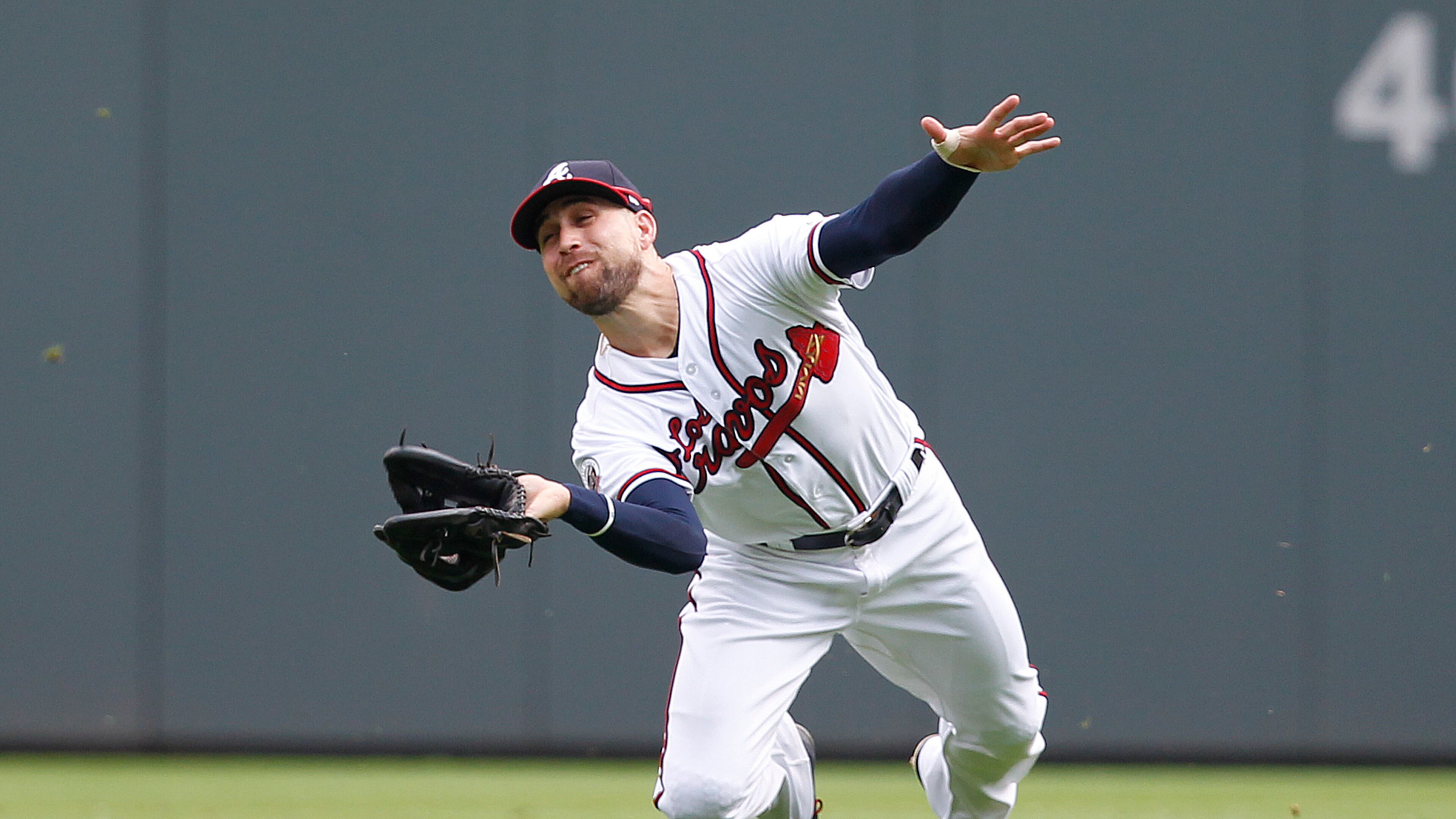 Atlanta Braves center fielder Ender Inciarte makes a diving catch on a ball hit by New York Mets' Kevin Plawecki in the fifth inning of a baseball game against the New York Mets in Atlanta, Sunday, Sept. 17, 2017. (AP Photo/Tami Chappell)