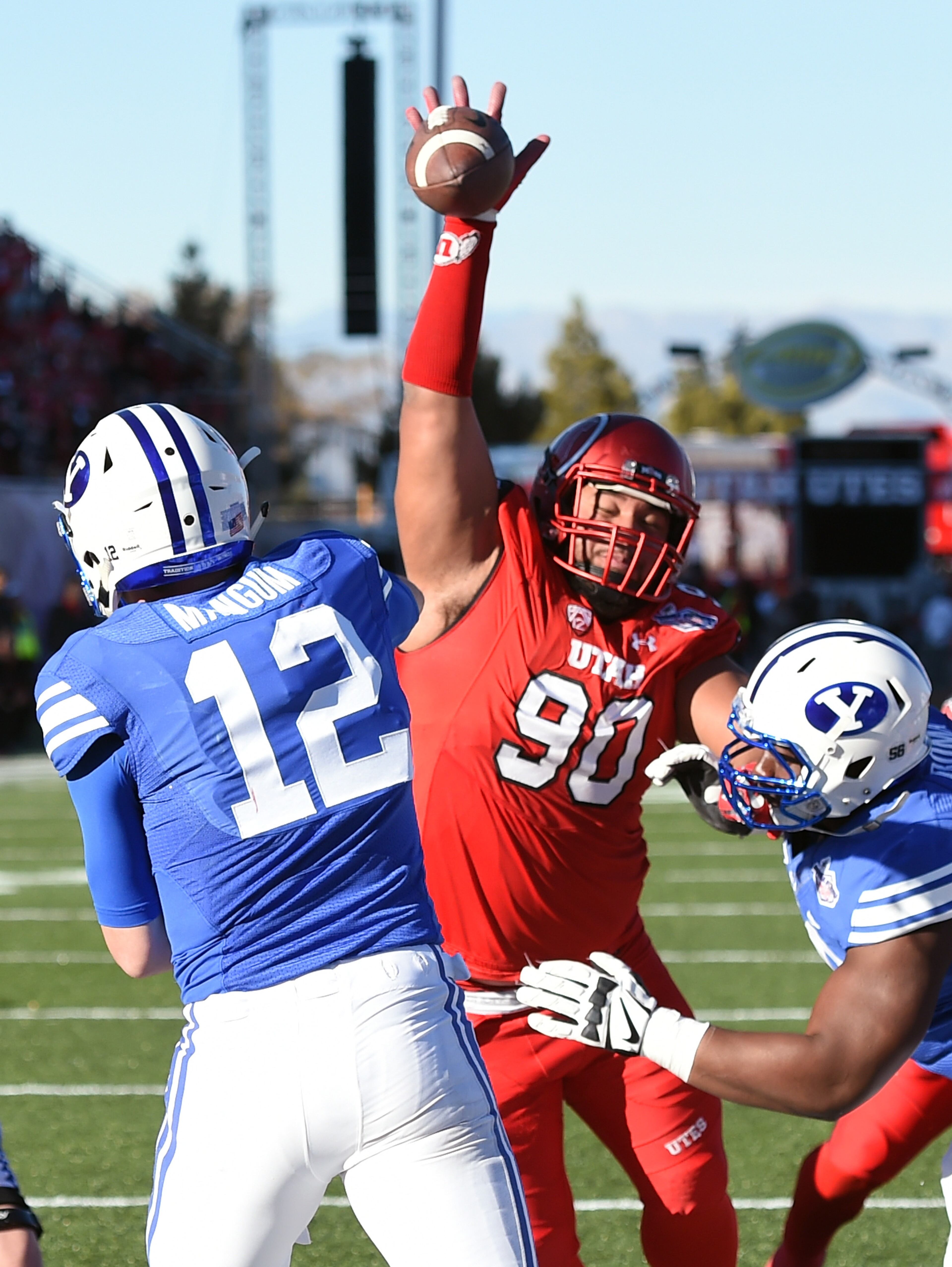 LAS VEGAS, NV - DECEMBER 19: Defensive tackle Stevie Tu'ikolovatu #90 of the Utah Utes blocks a pass by quarterback Tanner Mangum #12 of the Brigham Young Cougars during the Royal Purple Las Vegas Bowl at Sam Boyd Stadium on December 19, 2015 in Las Vegas, Nevada. (Photo by Ethan Miller/Getty Images)