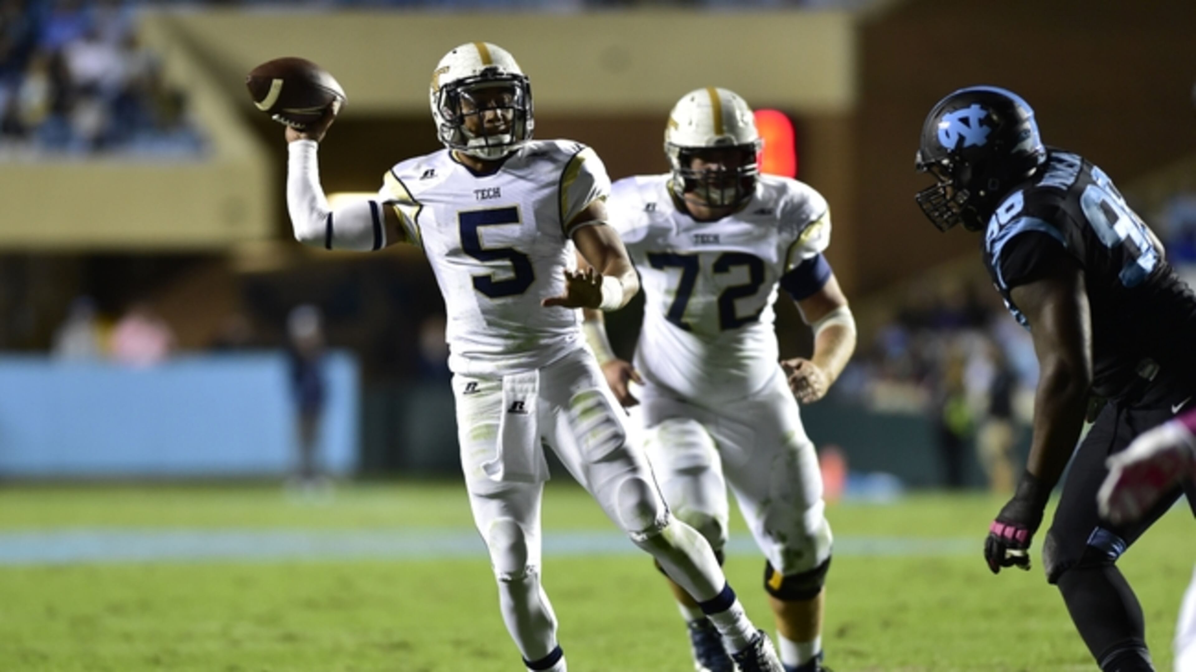 Oct 18, 2014; Chapel Hill, NC, USA; Georgia Tech Yellow Jackets quarterback Justin Thomas (5) throws a touchdown pass as North Carolina Tar Heels defensive tackle Justin Thomason (98) pressures in the second quarter at Kenan Memorial Stadium. Mandatory Credit: Bob Donnan-USA TODAY Sports Georgia Tech quarterback Justin Thomas' six touchdowns on third-and-long are the most of any quarterback in the ACC. (ASSOCIATED PRESS)