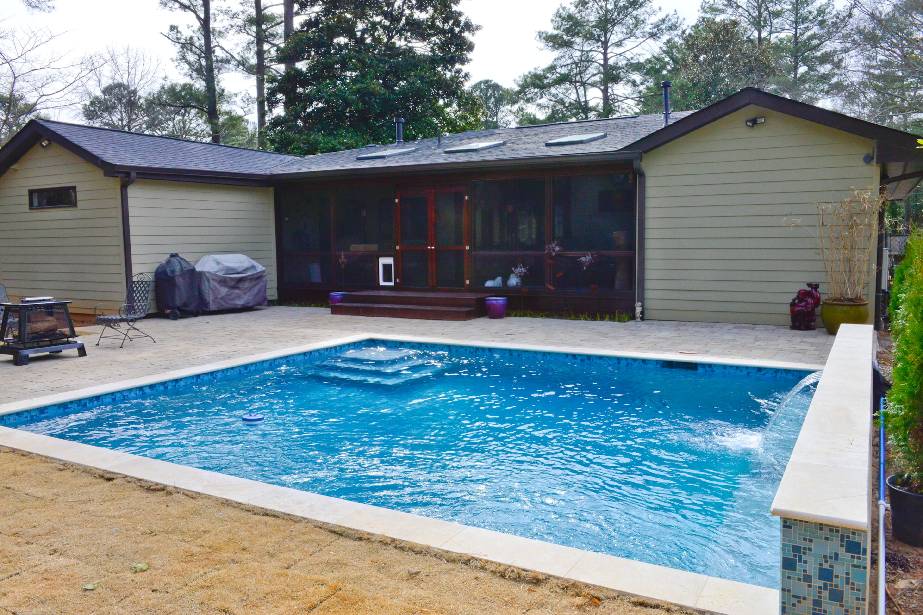 Michael Bush loves the sound of the water from the fountains in the pool that he and fellow homeowner Johnny Mitchell had built in the backyard of their Decatur home. Bush said the yard was the perfect place for the new pool, which can be seen while entering the front door looking through the house.