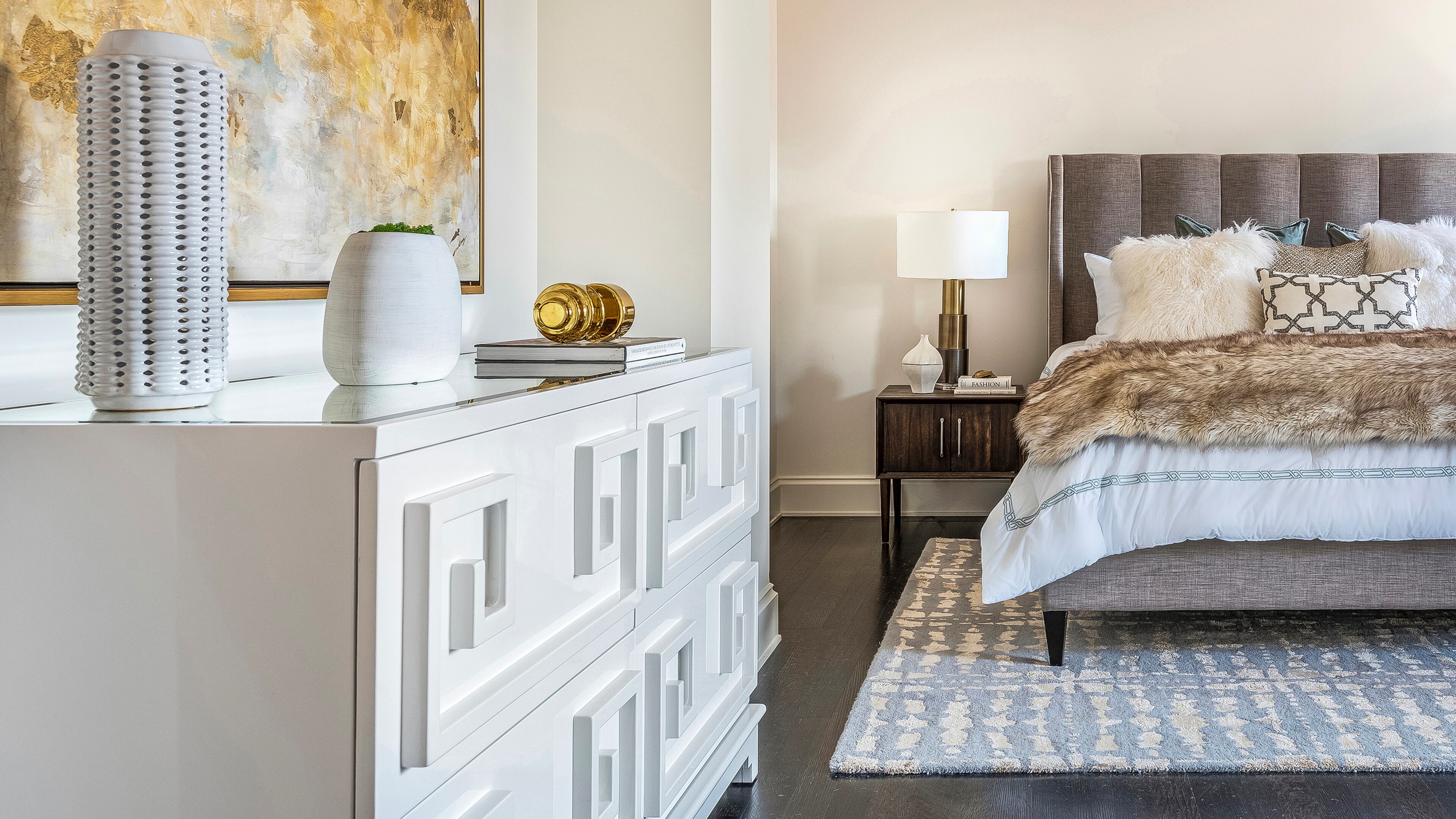 A warm gray upholstered bed helps create a soothing atmosphere. Contributed by Design Recipes