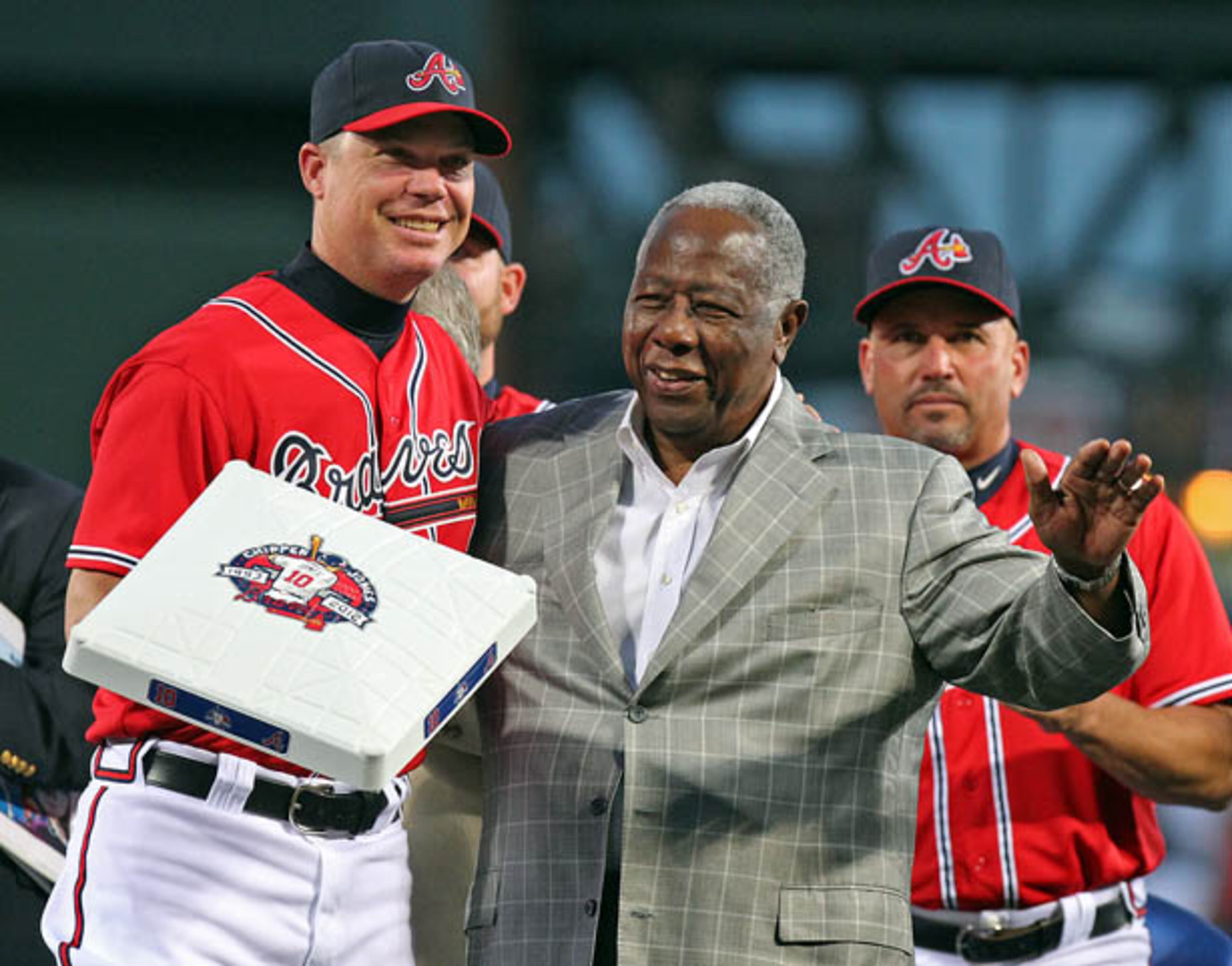 Hank Aaron presents Chipper Jones with a third base bag in honor of Chipper Jones tribute night.