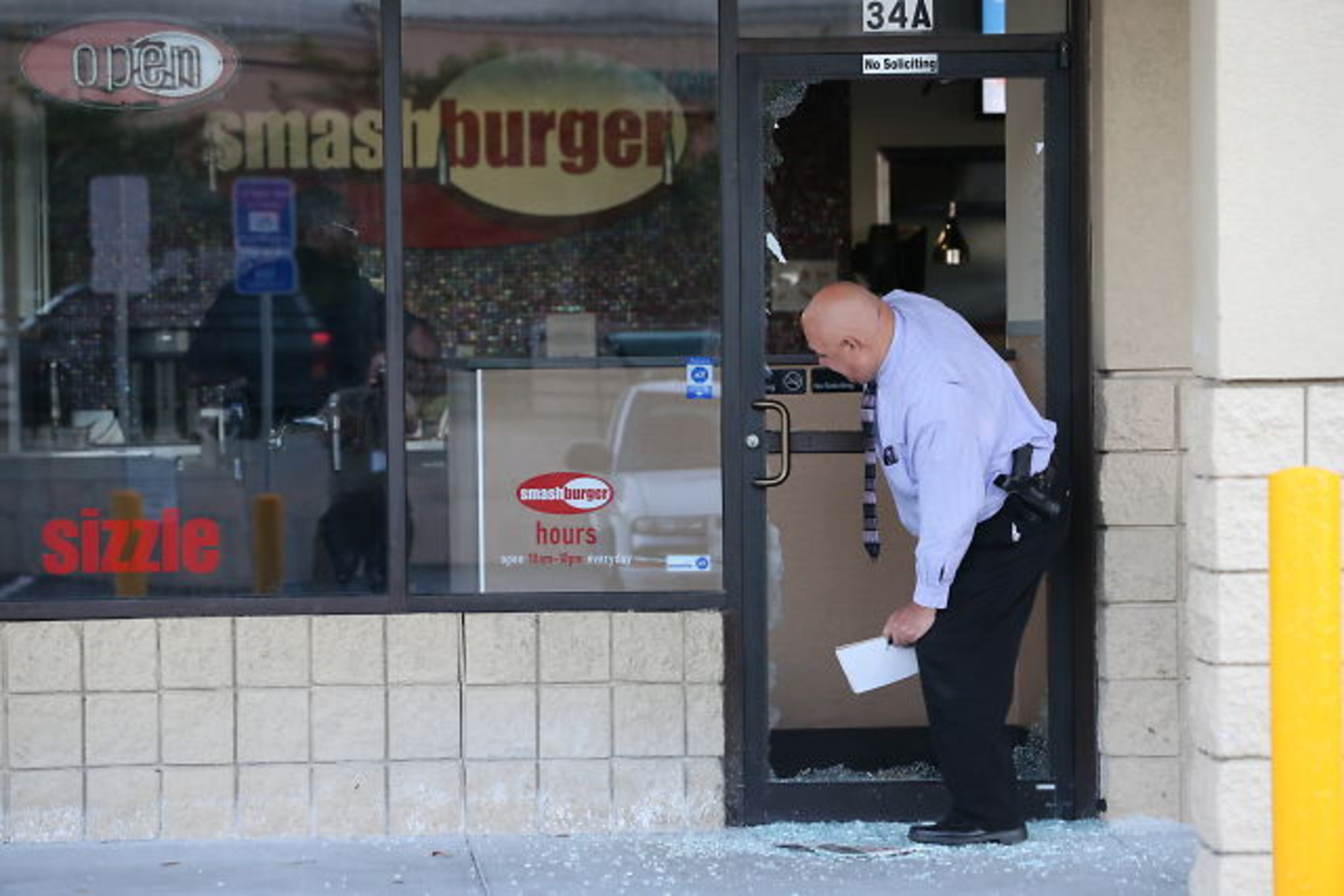 Smash-and-grab burglars hit the Smashburger restaurant and the Classic Touch Cleaners at the Buckhead Crossing shopping center just before daybreak Tuesday. JOHN SPINK / JSPINK@AJC.COM
