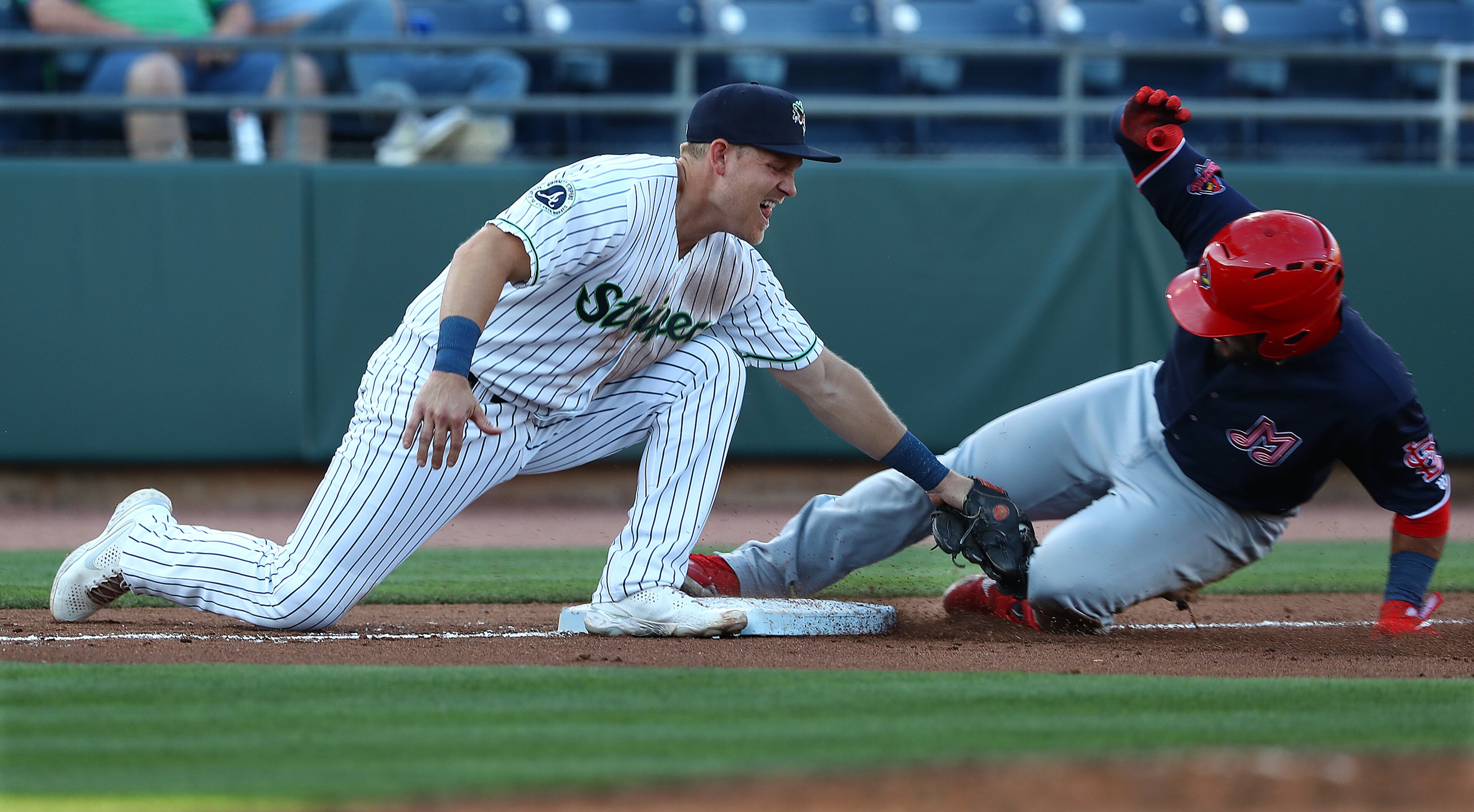 Gwinnett Stripers third baseman Pat Valaika puts the tag on Memphis RedbirdsPaul DeJong for the out during the 4th inning of a MLB minor league game on Tuesday, May 17, 2022, in Lawrenceville. “Curtis Compton / Curtis.Compton@ajc.com”