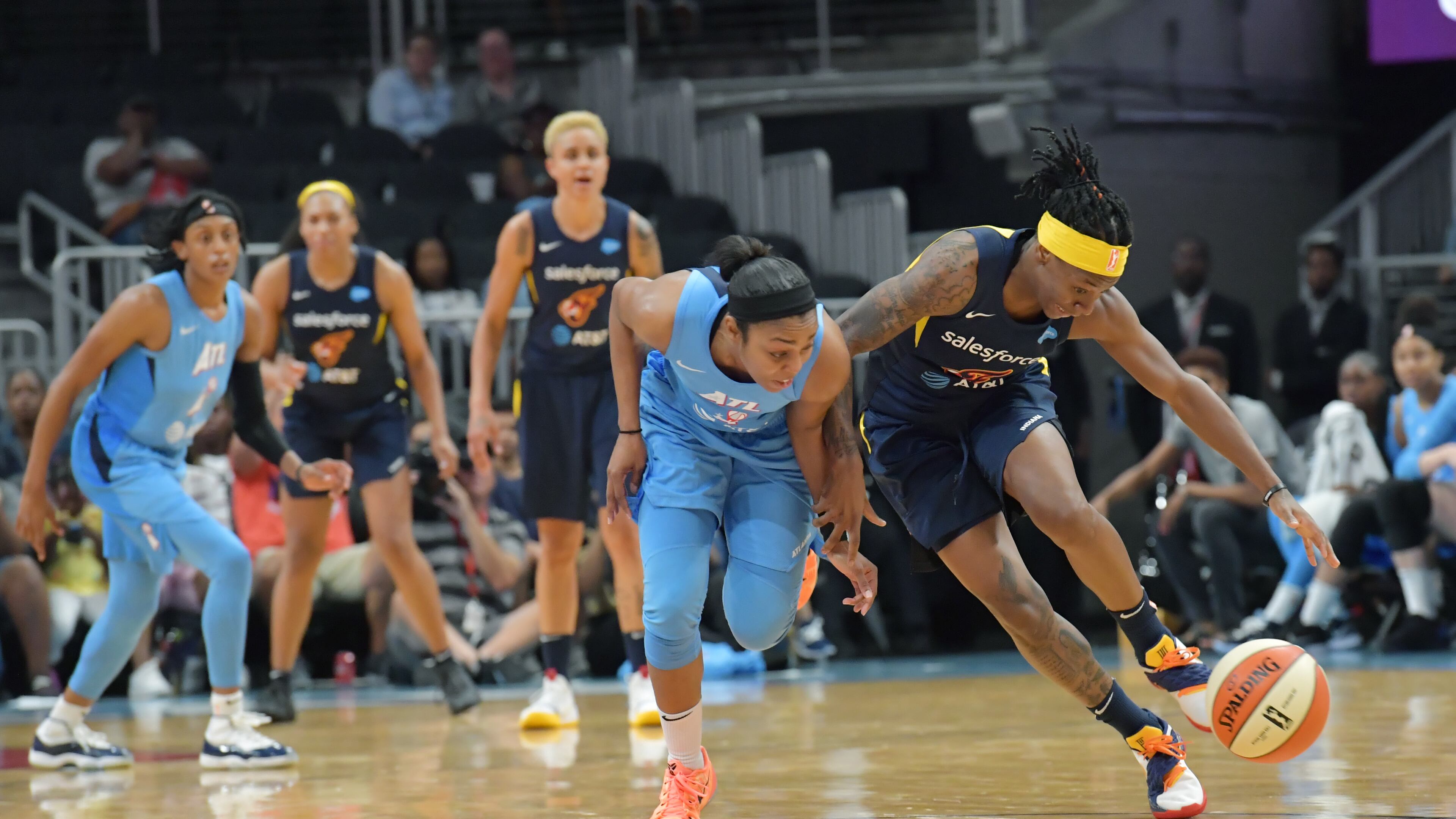 June 19, 2019 Atlanta - Atlanta Dream guard Renee Montgomery and Indiana Fever guard Erica Wheeler (right) fight for a loose ball during the second half of WNBA basketball game at State Farm Arena in Atlanta on Wednesday, June 19, 2019. Atlanta Dream won 88-78 over the Indiana Fever. HYOSUB SHIN / HSHIN@AJC.COM