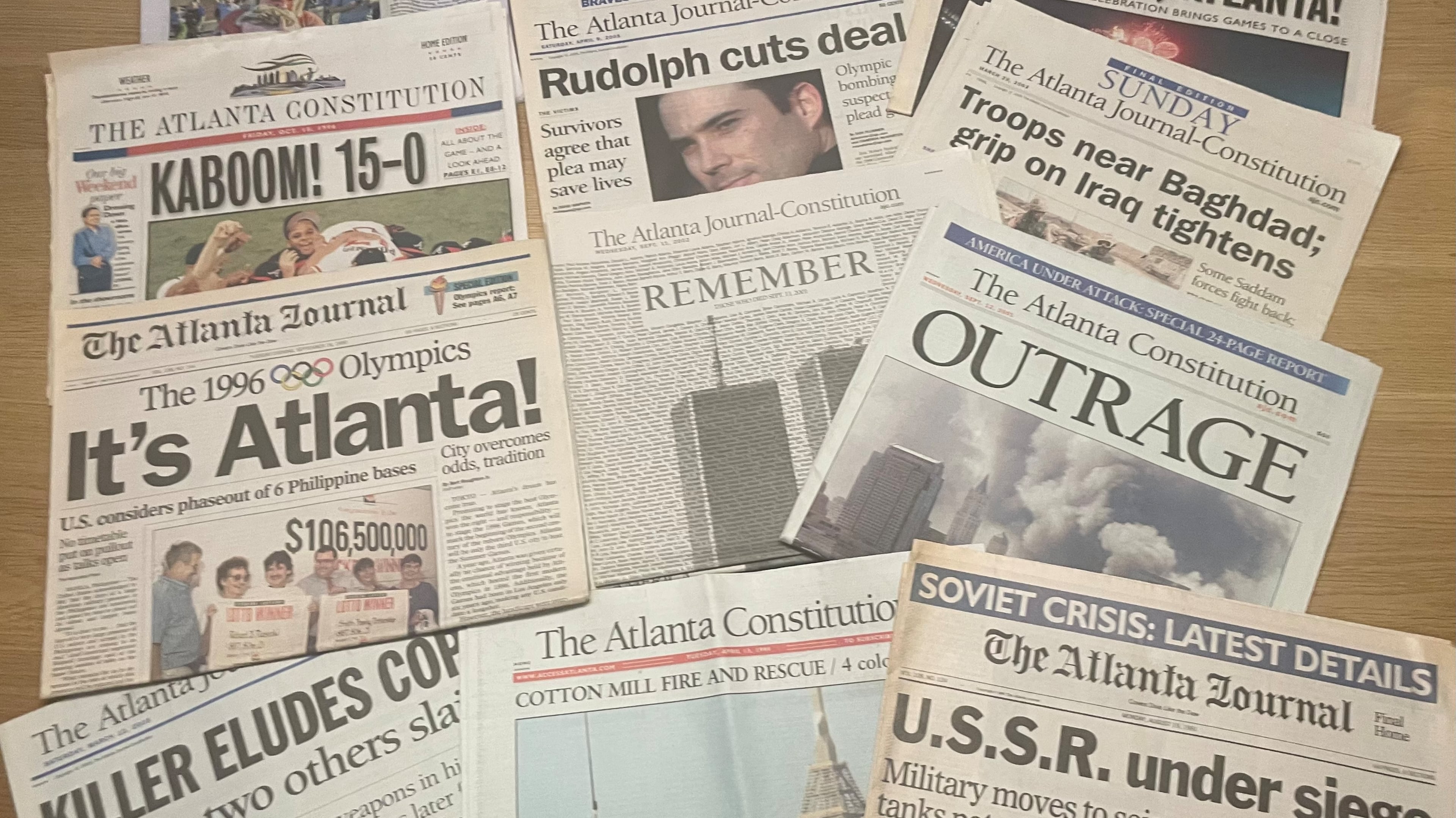 Copies of notable Atlanta Journal-Constitution headlines have been saved in columnist Bill Torpy’s basement. The newspaper is taking a new direction by becoming an all-digital news outlet. (Bill Torpy/AJC)