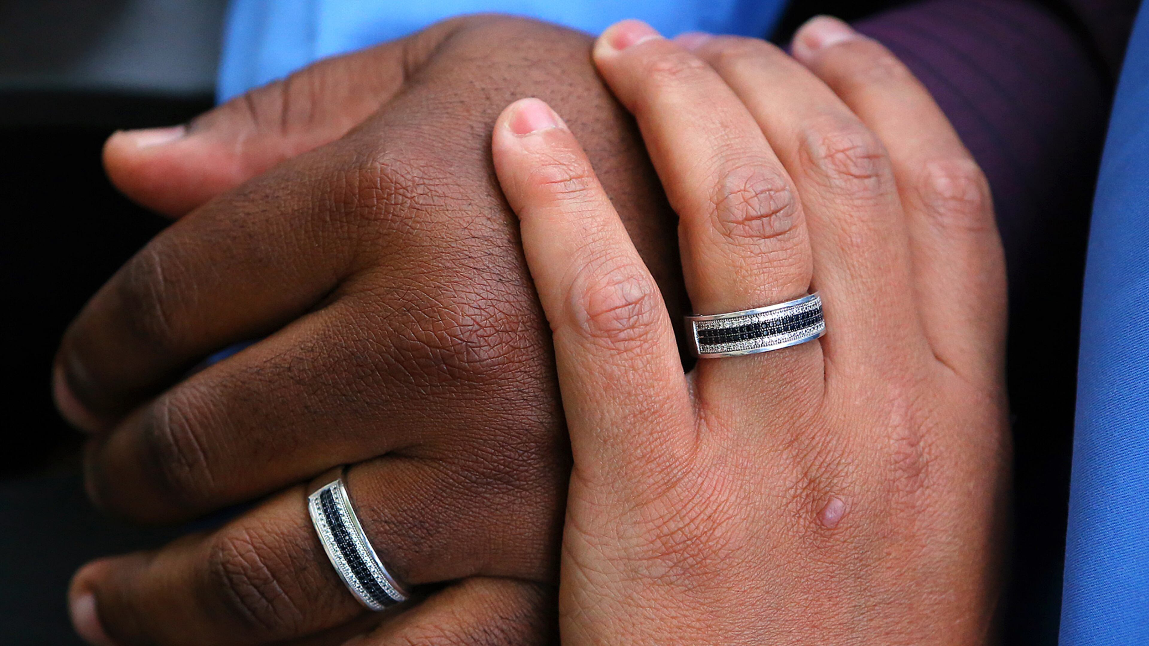 Shelton Stroman and Christopher Inniss wear matching rings to show their commitment, at their Snellville home in April 2014.