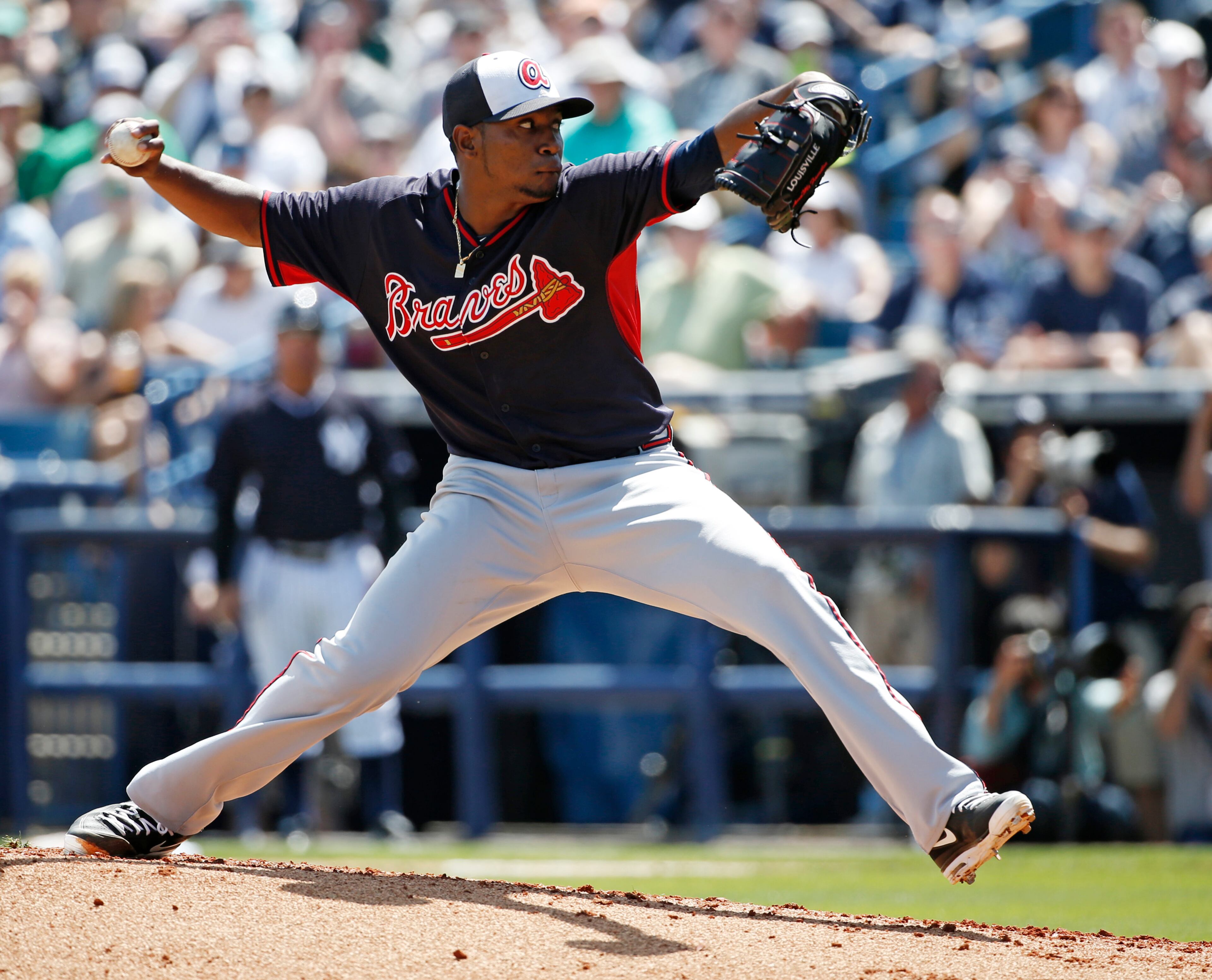 Atlanta Braves starting pitcher Julio Teheran winds up in the first inning of a spring exhibition baseball game against the New York Yankees in Tampa, Fla., Sunday, March 16, 2014. (AP Photo/Kathy Willens)
