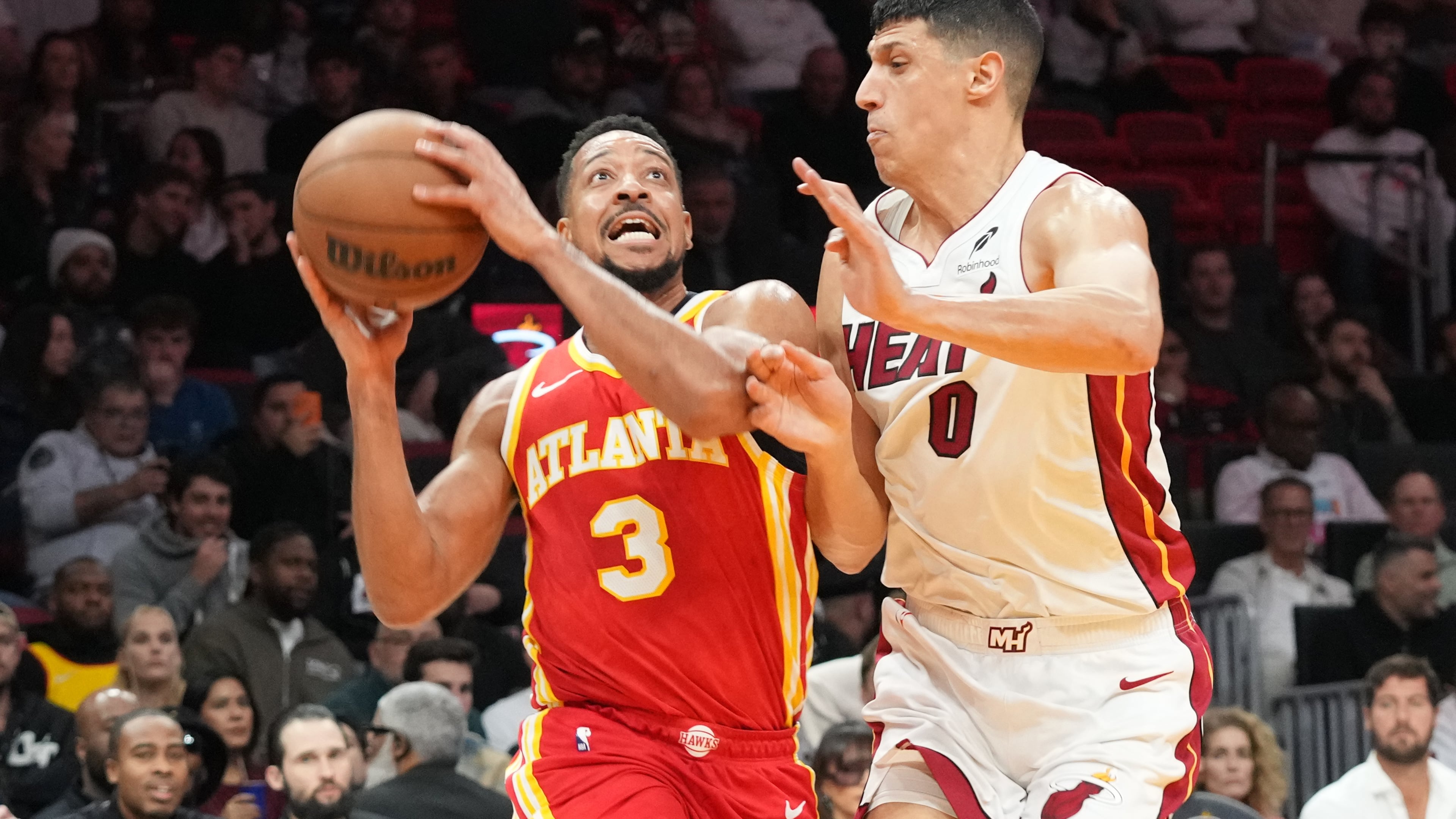 Atlanta Hawks guard CJ McCollum (3) drives to the basket as Miami Heat forward Simone Fontecchio (0) defends during the first half of an NBA basketball game Tuesday, Feb. 3, 2026, in Miami. (AP Photo/Marta Lavandier)