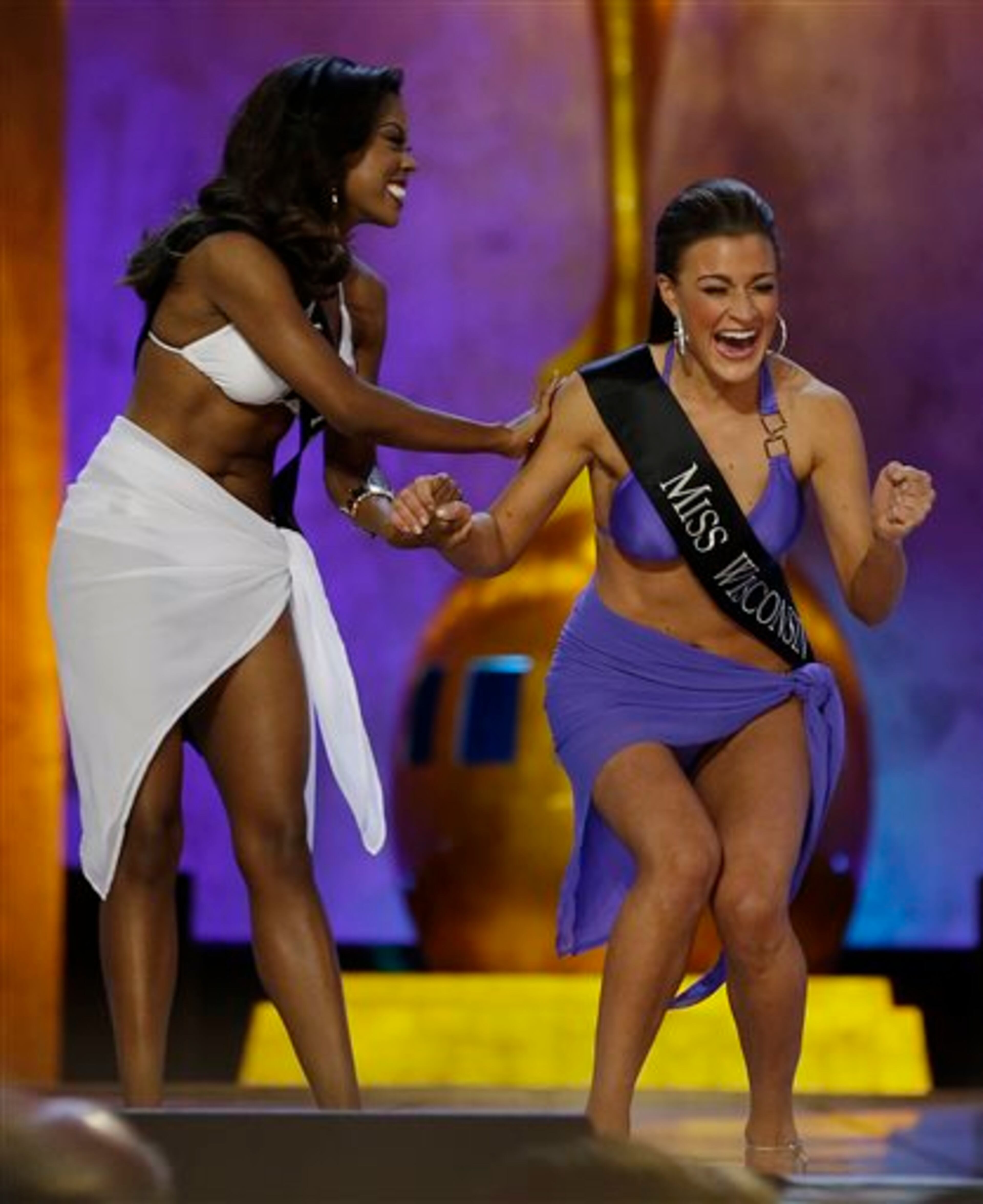Miss Wisconsin Paula Mae Kuiper, right, reacts after finding out she's advancing beyond the lifestyle round as Miss Texas Ivana Hall congratulates her during the Miss America 2014 pageant, Sunday, Sept. 15, 2013, in Atlantic City, N.J. (AP Photo/Mel Evans)