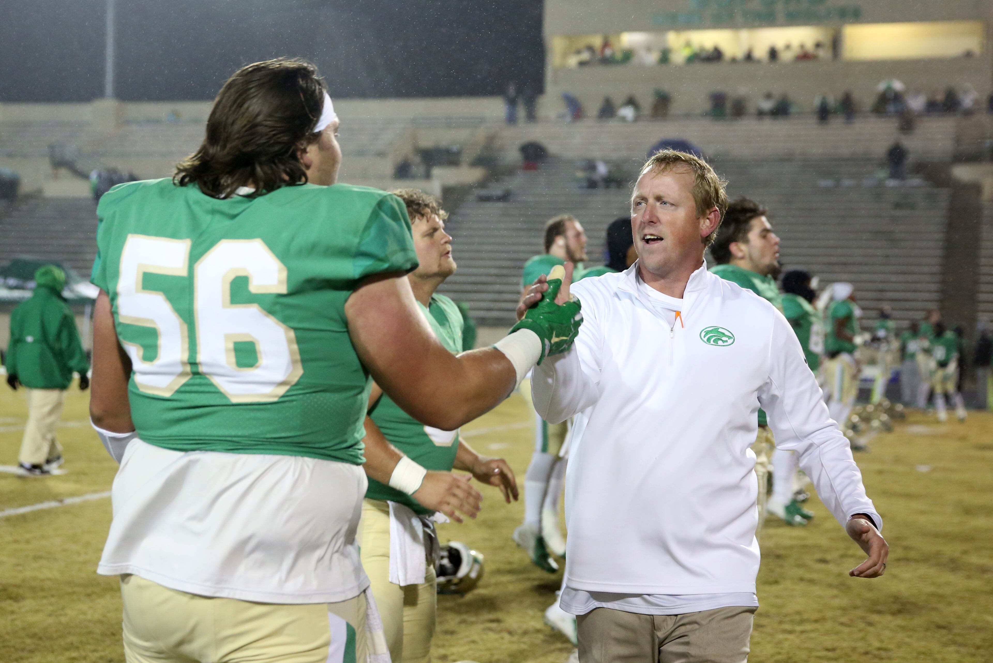 November 23, 2018 - Buford, Ga: Buford coach John Ford greets lineman Reece McIntyre (56) before their game against Bainbridge at Buford High School Friday, November 23, 2018, in Buford, Ga. This is the quarter finals of the Class 5A state playoffs. (JASON GETZ/SPECIAL TO THE AJC)