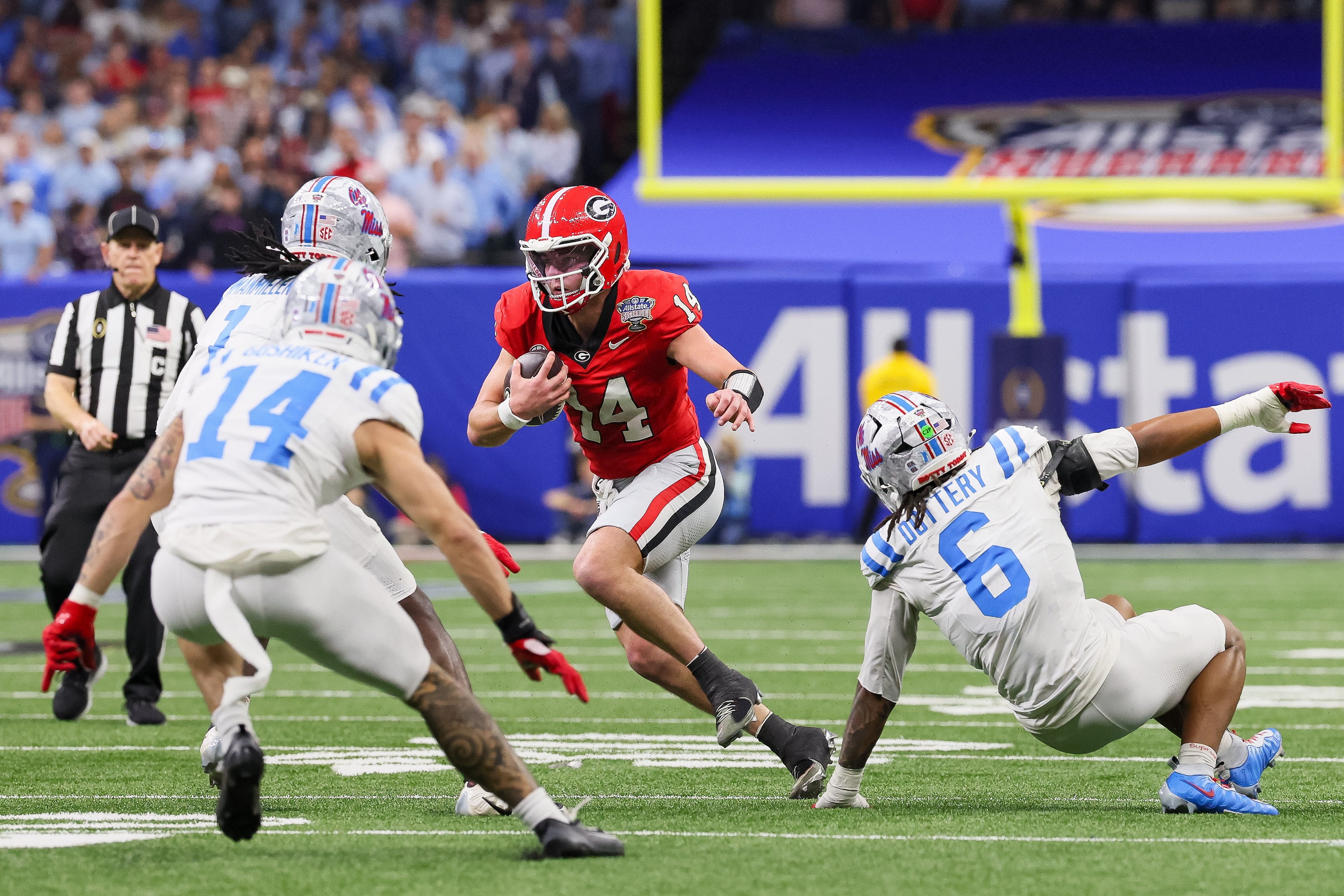 Georgia Bulldogs quarterback Gunner Stockton (14) runs under pressure from Ole Miss Rebels linebacker TJ Dottery (6) and safety Kapena Gushiken (14) during the third quarter of the College Football Playoff quarterfinal game at the Sugar Bowl in the Caesars Superdome, Thursday, Jan. 1, 2026, in New Orleans. (Jason Getz/AJC)