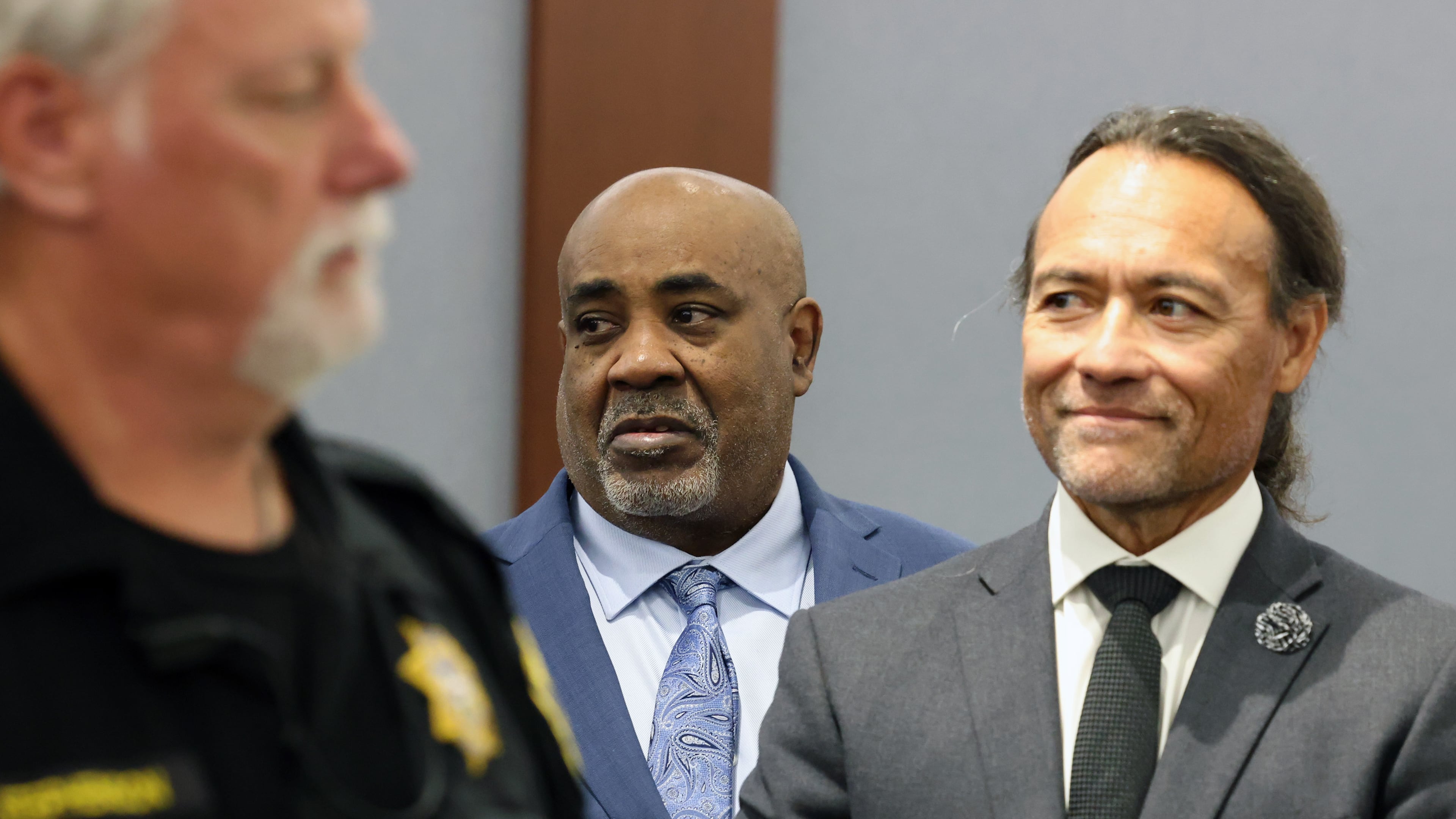 Duane Davis, center, stands with his attorney Michael Sanft, right, as prospective jurors enter the courtroom during the fourth day of jury selection for his murder trial in Clark County District Court at the Regional Justice Center on Thursday, Aug. 13, 2026, in Las Vegas. Davis was indicted on murder charges for his involvement in the killing of rapper Tupac Shakur in 1996. (Bizuayehu Tesfaye/Las Vegas Review-Journal via AP, Pool)
