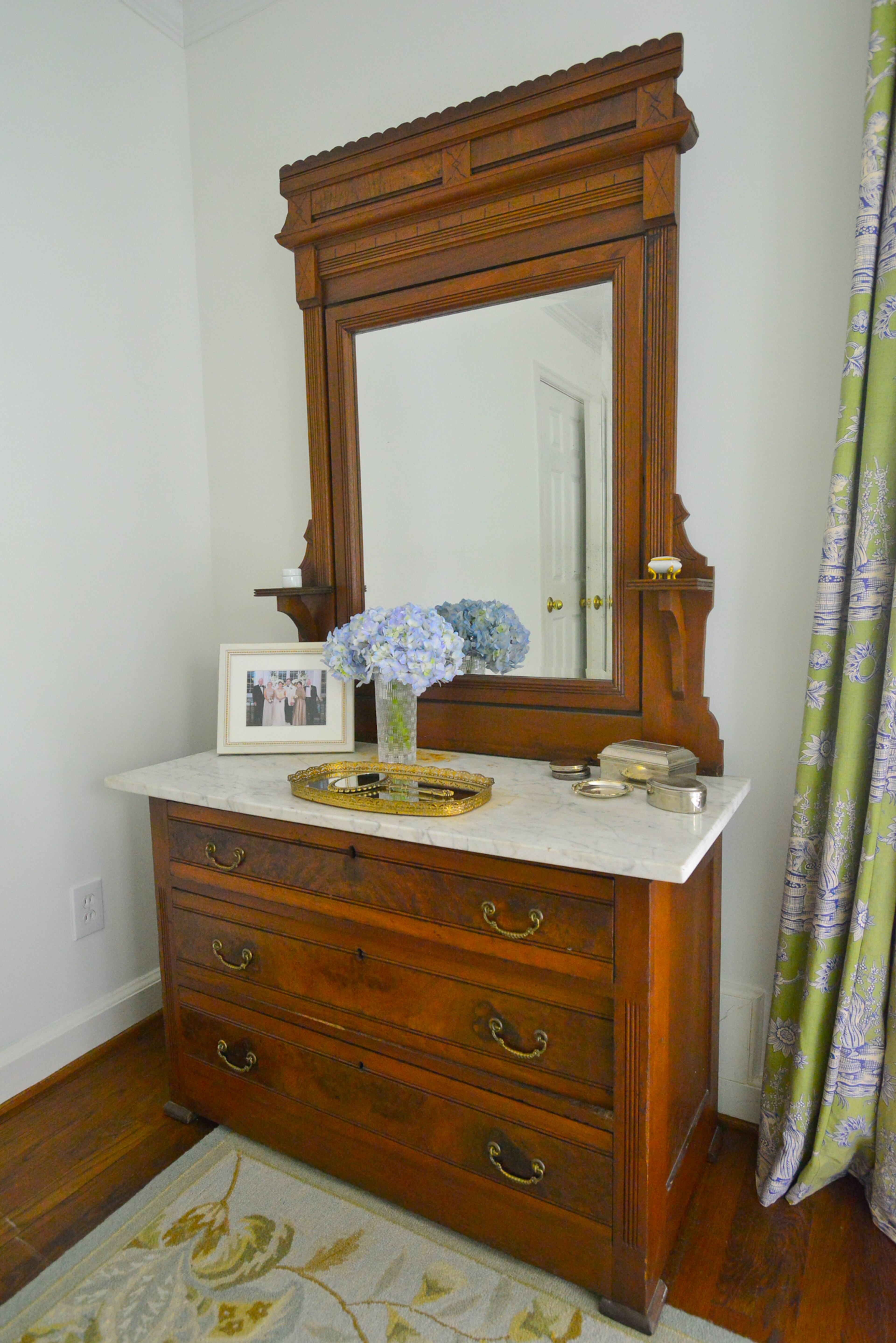 A marble-topped dresser that originally belonged to the great-grandparents of homeowner Catherine Callaway now is in a guest bedroom of the Buckhead home she shares with husband TJ.