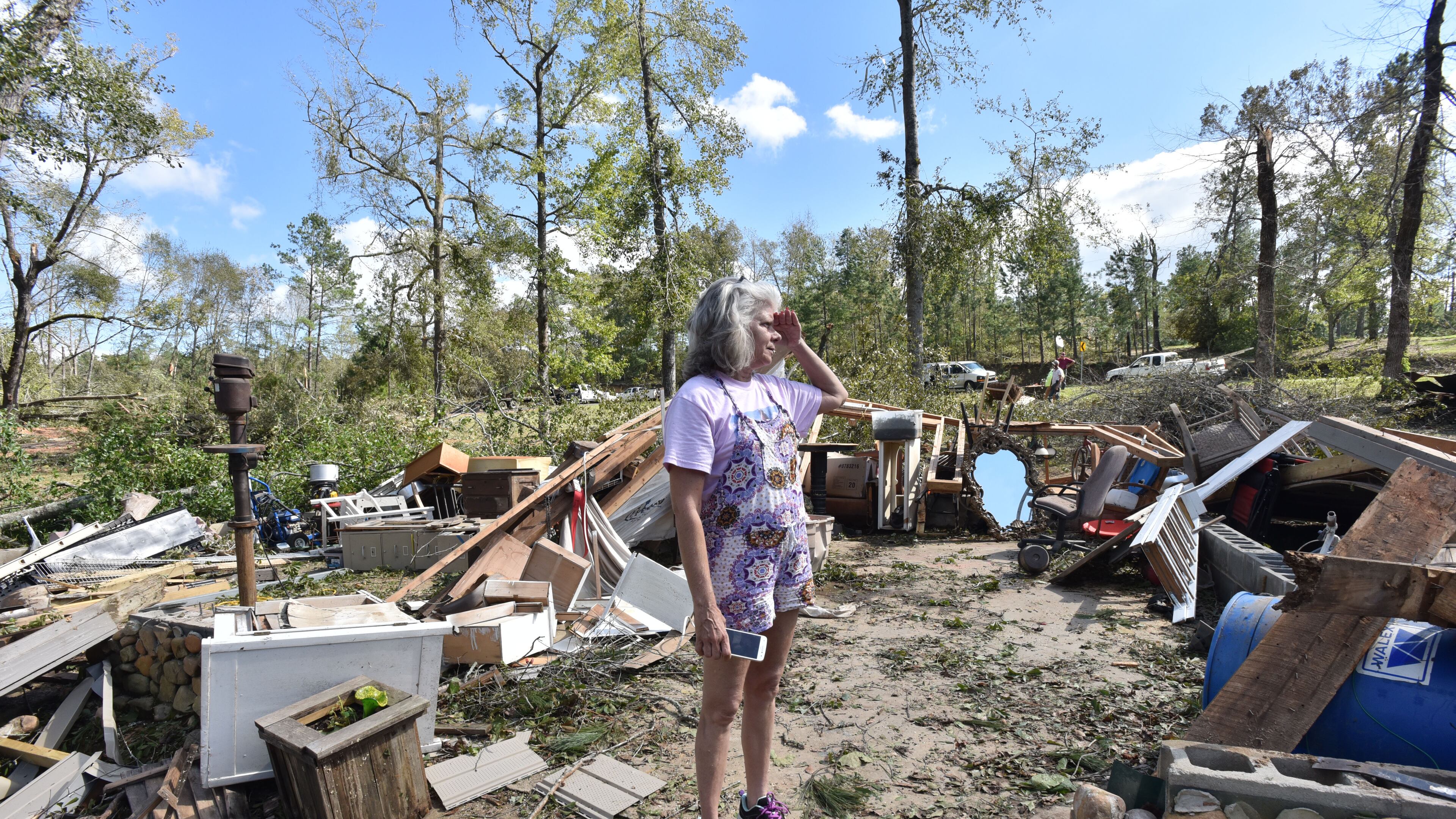 Sharon Granade stands on her destroyed two-car garage after Tropical Storm Michael passed on Flint River Estates Road in Roberta, Ga. on Thursday, October 11, 2018. Tropical Storm Michael swept out of Georgia before sunrise, leaving a trail of destruction in its wake.