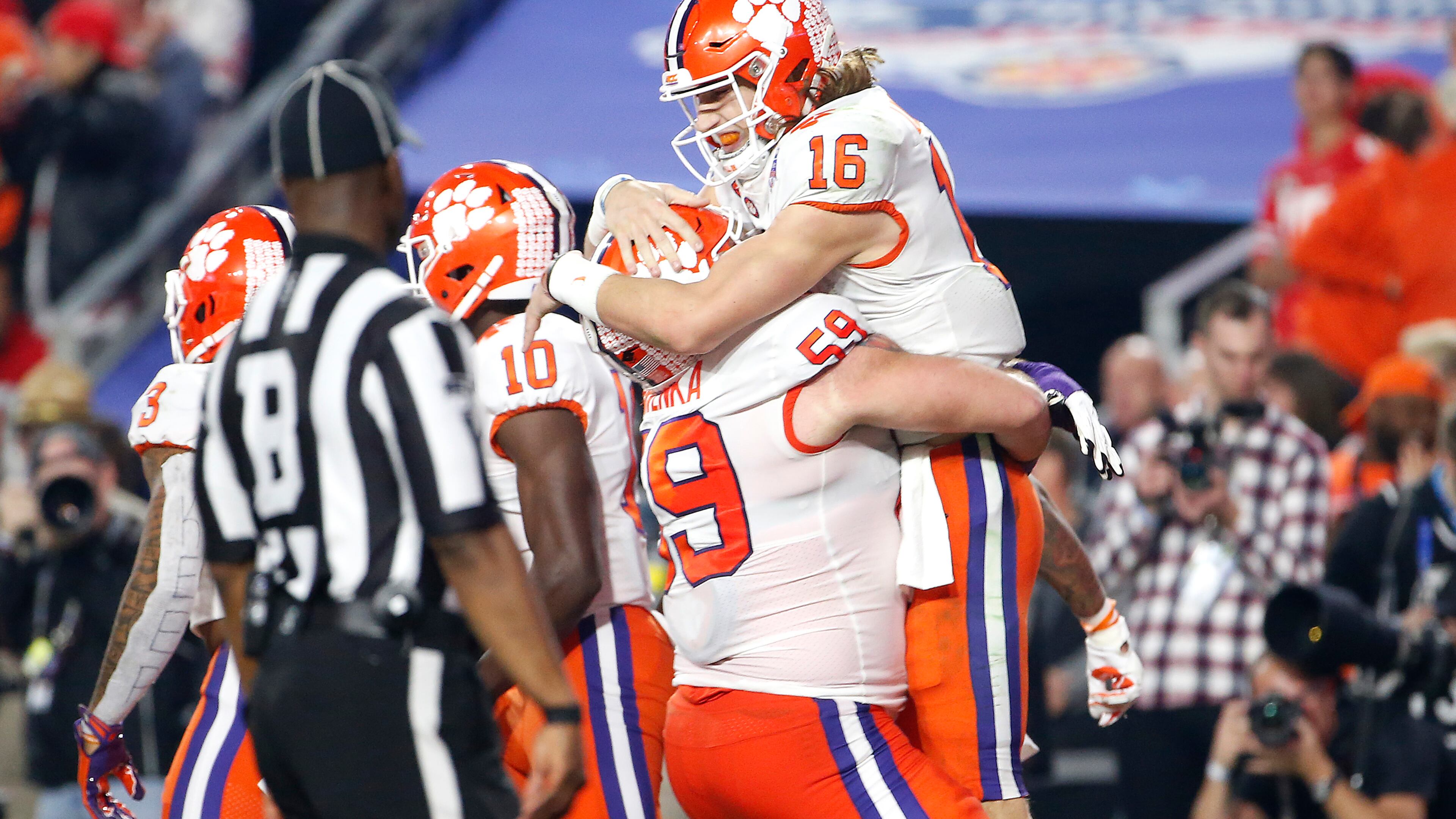 Trevor Lawrence #16 of the Clemson Tigers is congratulated by his teammate Gage Cervenka after his 67-yard touchdown run against the Ohio State Buckeyes. (Photo by Ralph Freso/Getty Images)