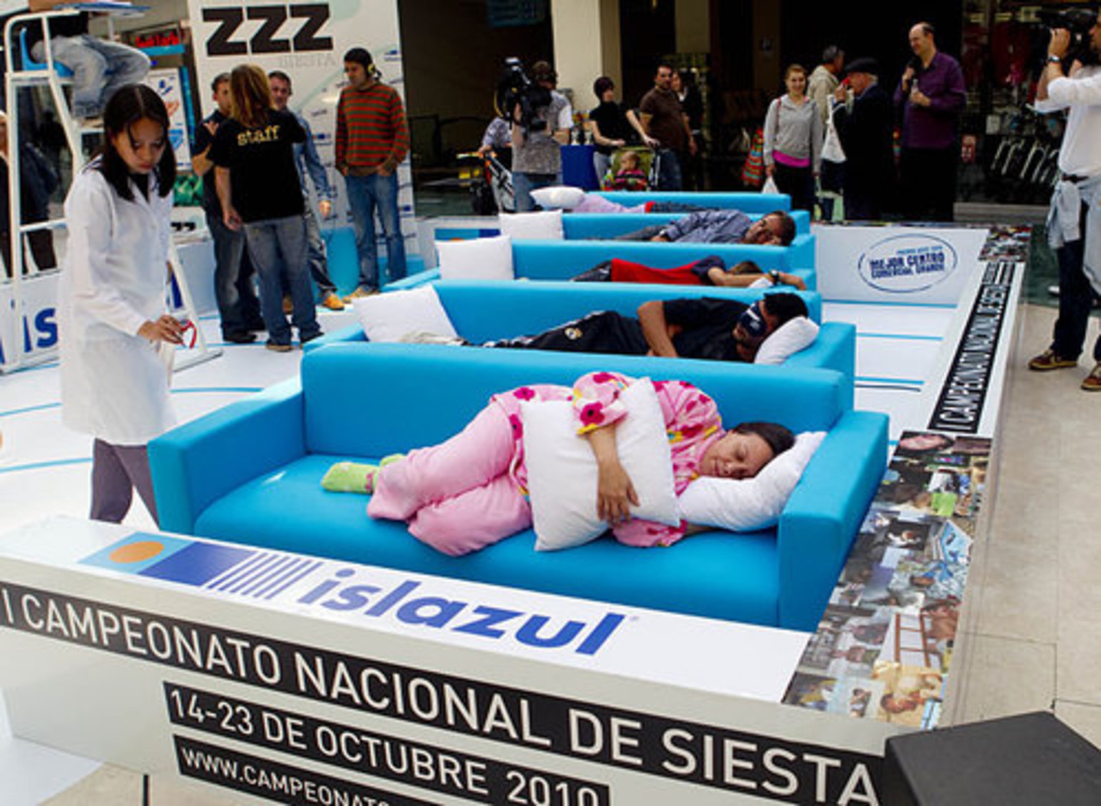 A doctor checks as people sleep a siesta during the first Siesta Championship in Madrid, Thursday, Oct. 14, 2010.